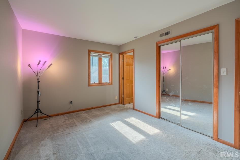 Wall-to-wall carpeting and neutral wall tones define this room