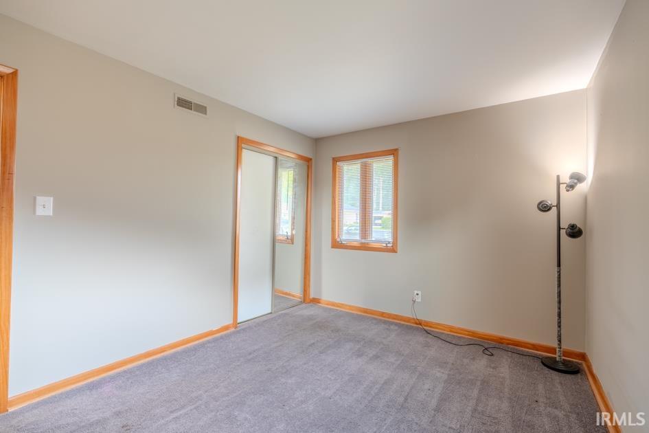 Neutral-toned walls with contrasting wood trim and window frame