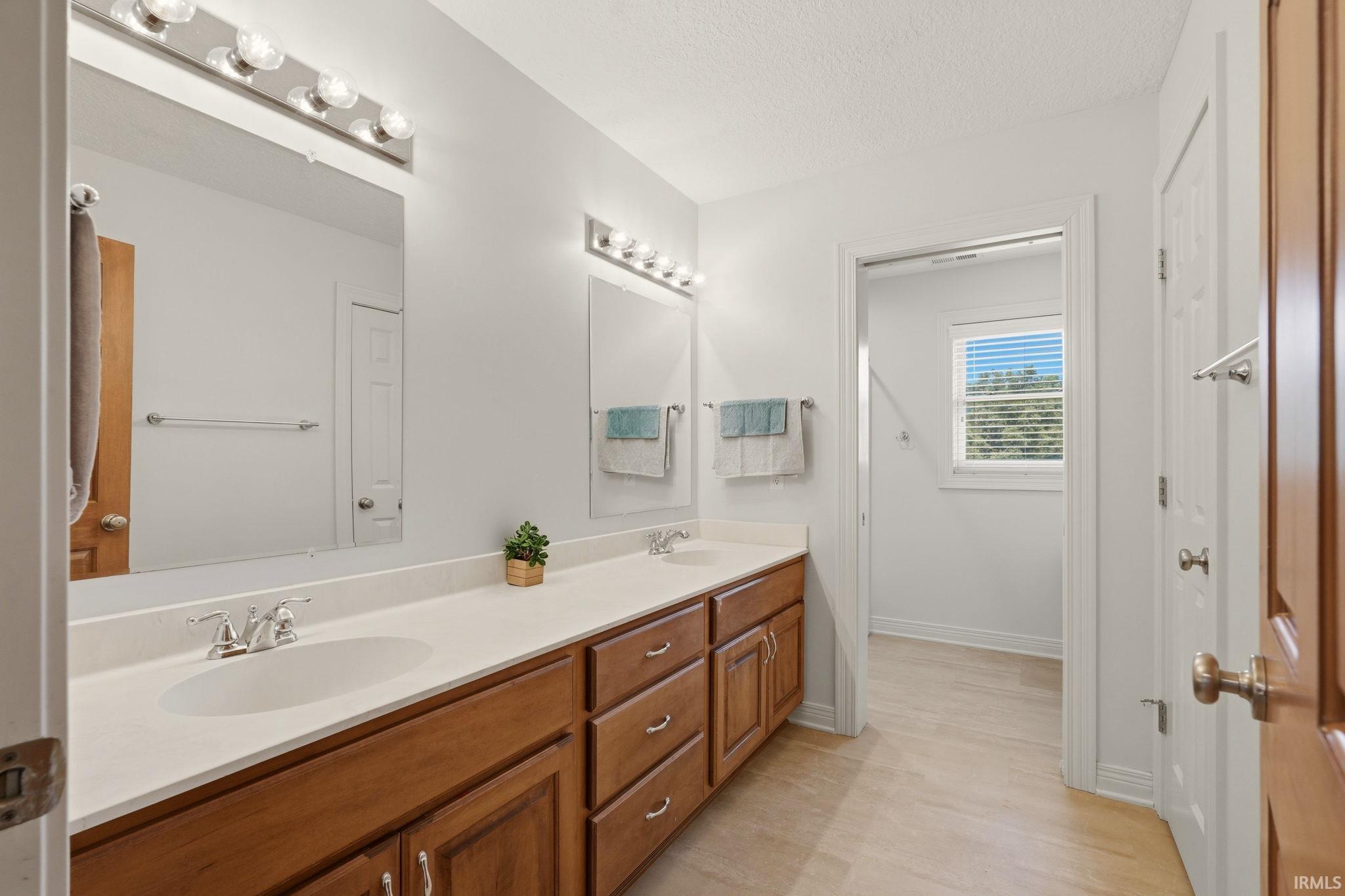 Double vanity with white countertops and integrated sinks