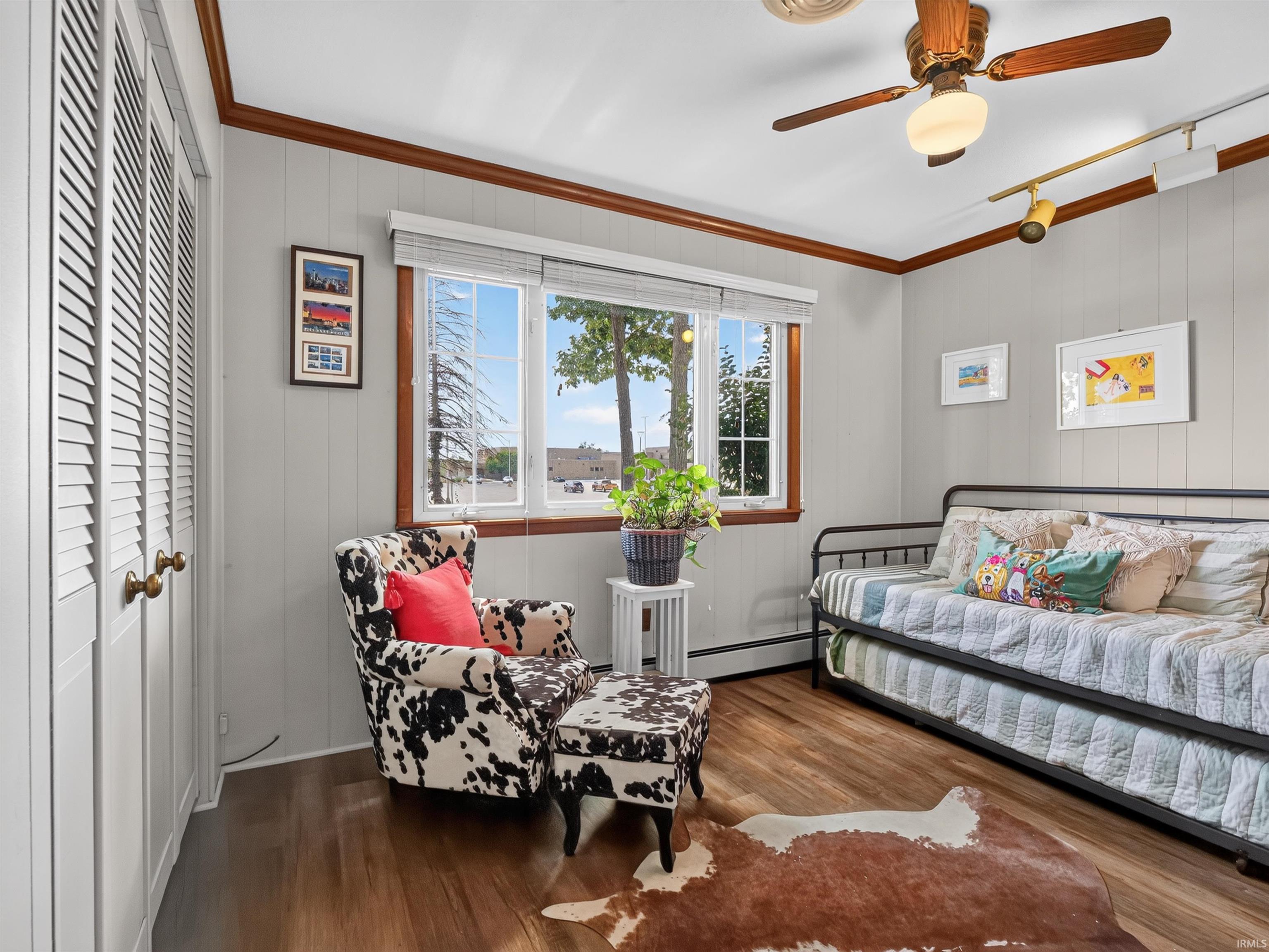 Bright room featuring wood-finish flooring, a large window