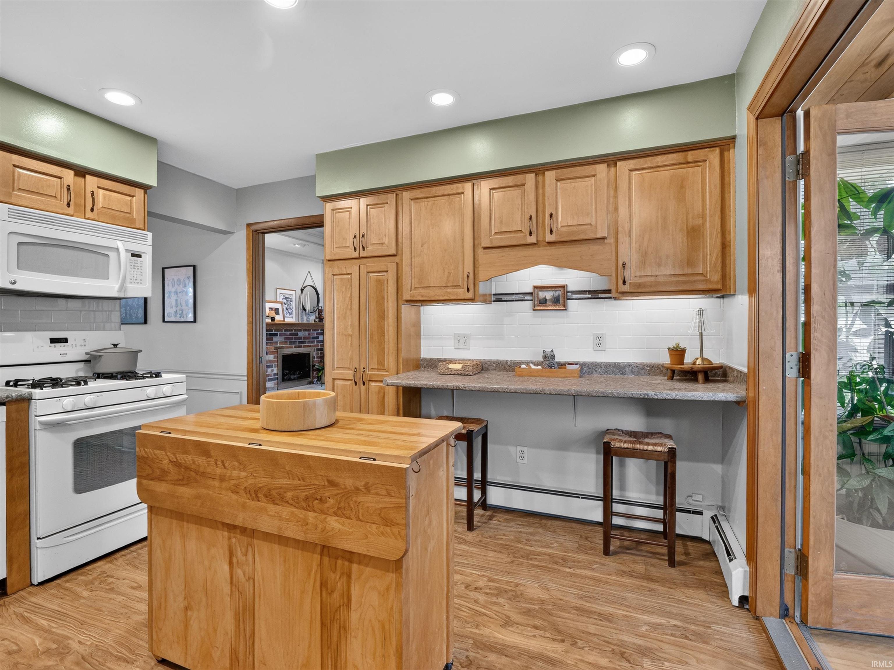 Kitchen featuring wood-finish flooring, recessed lighting, and light wood cabinetry
