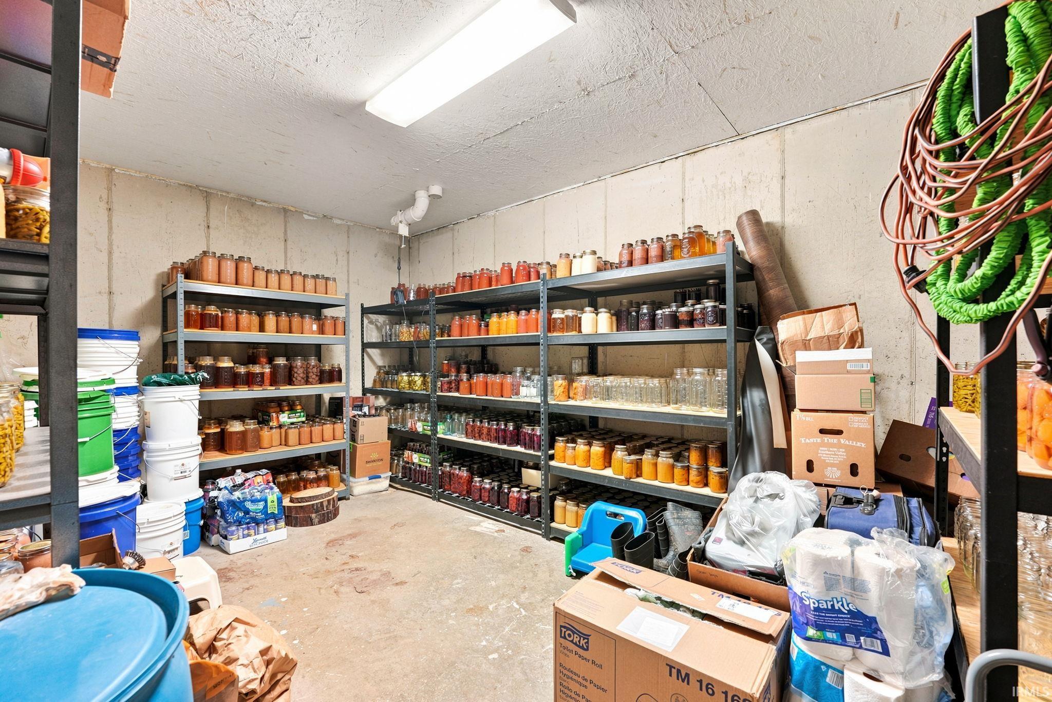 Utility room with concrete walls and flooring