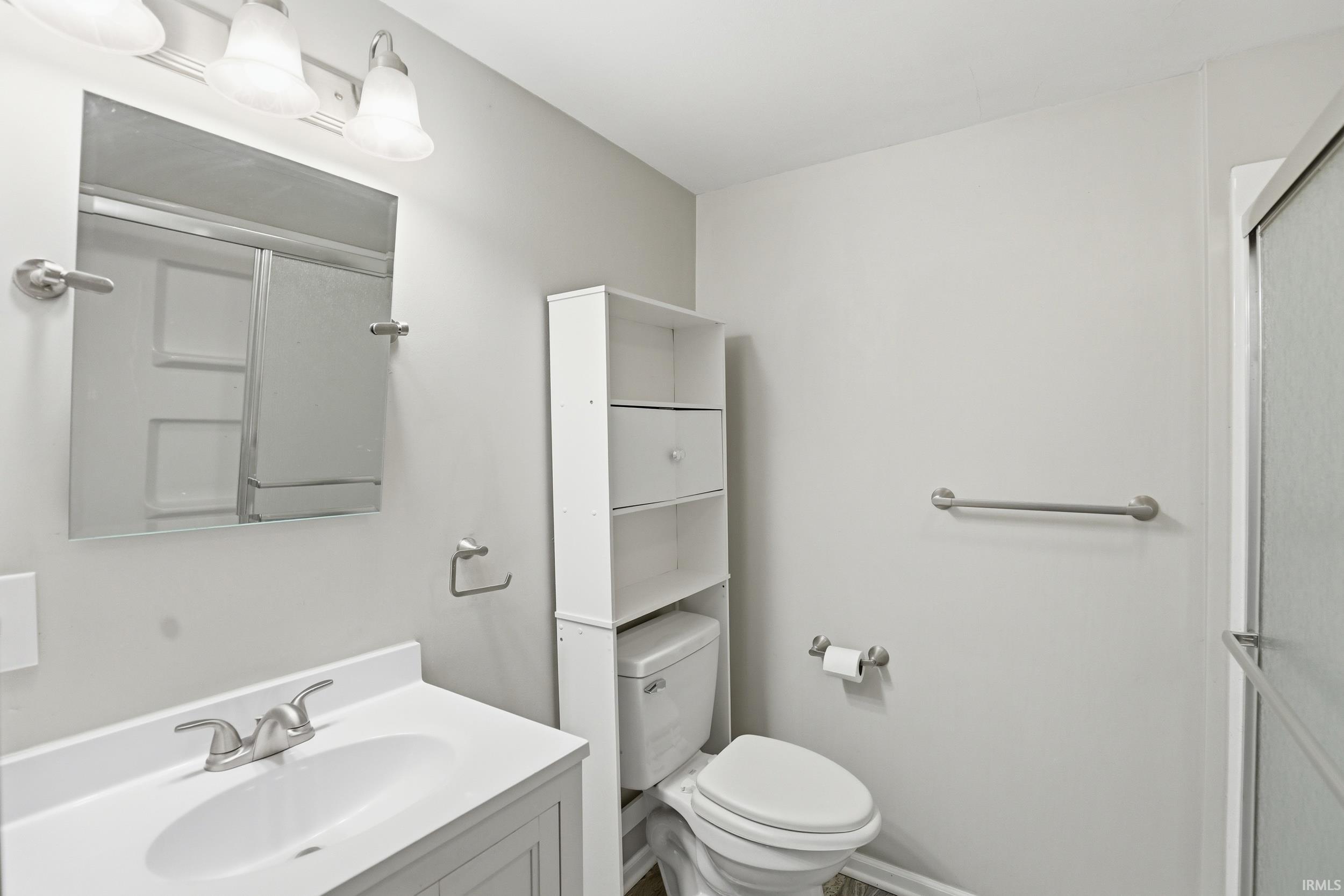 Full bathroom featuring vanity and a shower stall