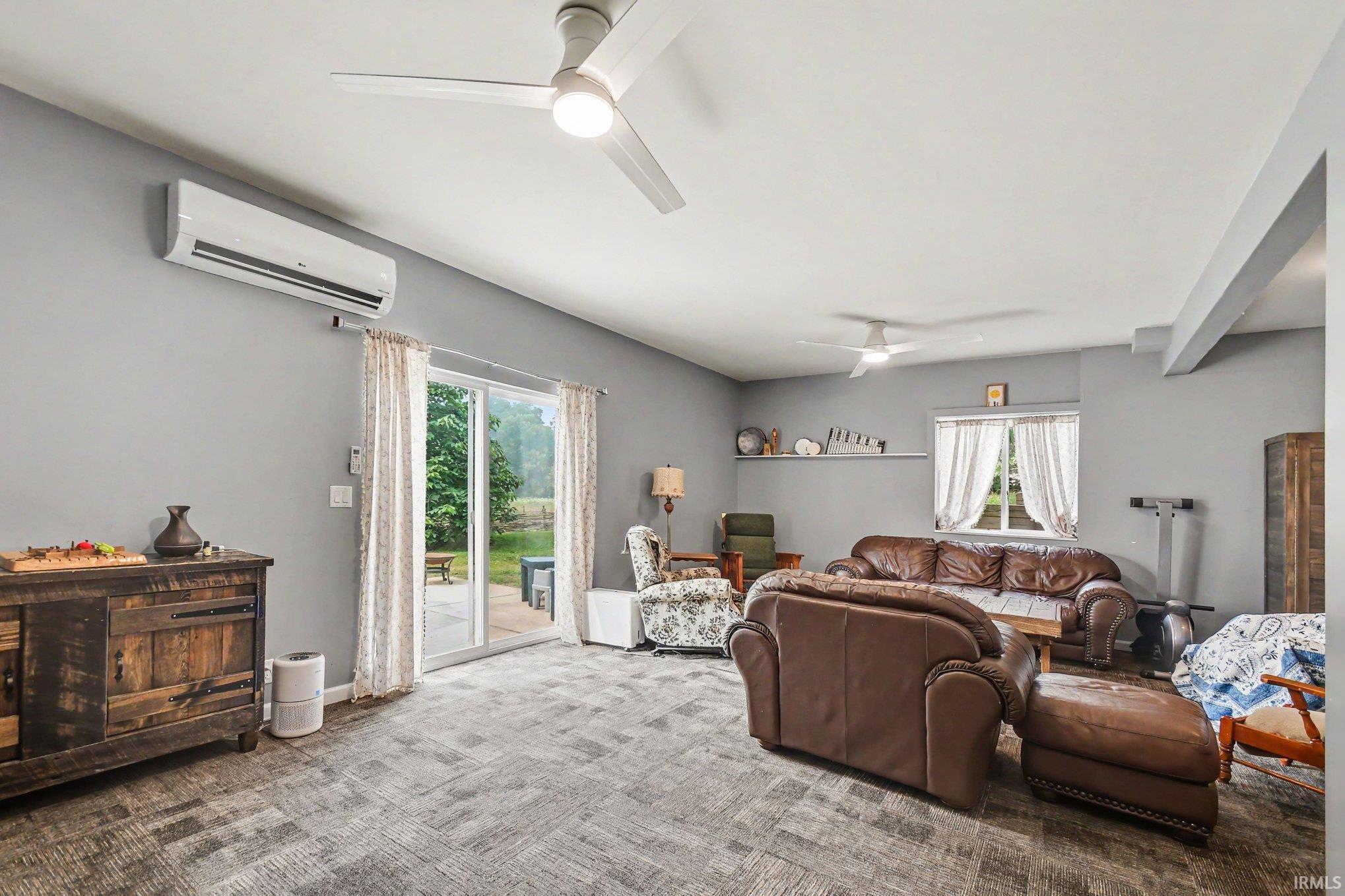 Spacious interior featuring a vaulted ceiling and a ceiling fan