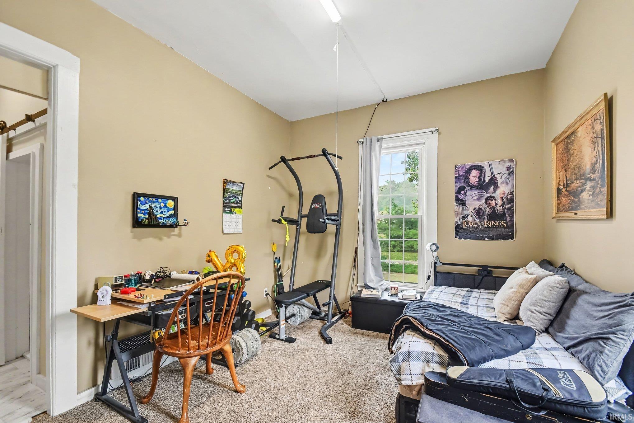 Bright interior space with warm-toned walls and carpeted flooring