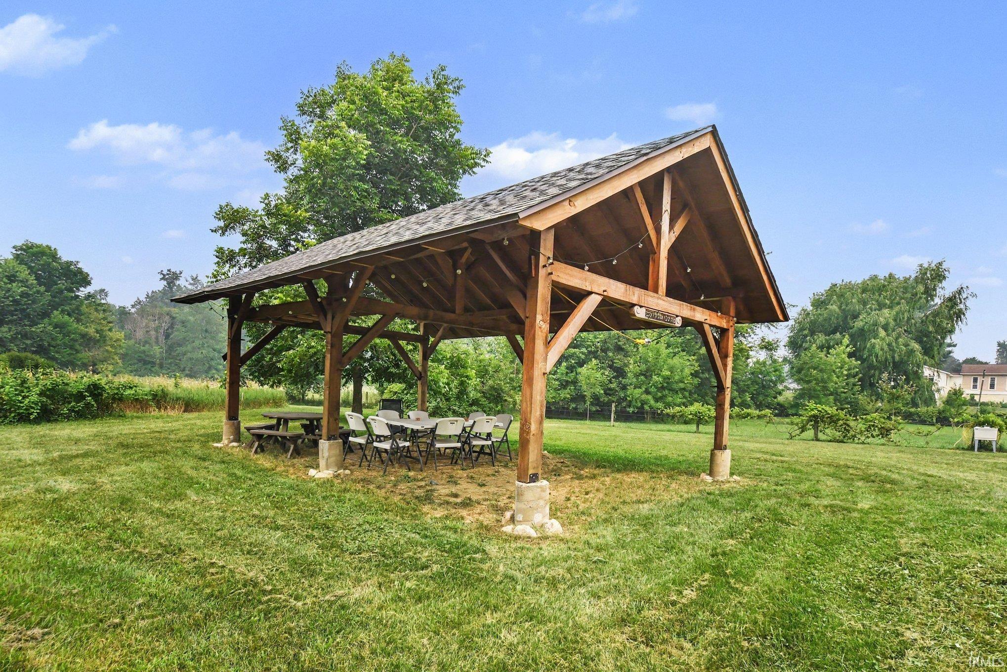 Spacious outdoor pavilion with a gabled roof and exposed wood beams