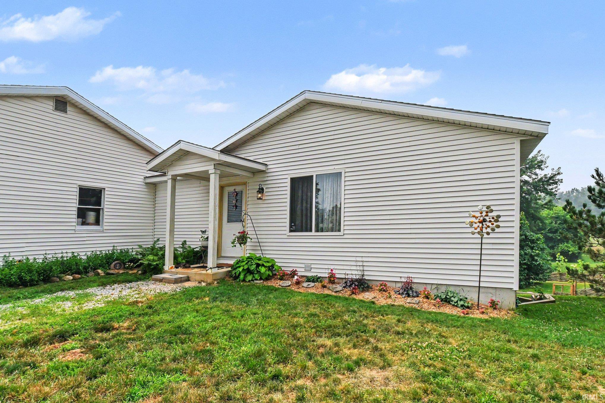 White siding exterior with a covered entry