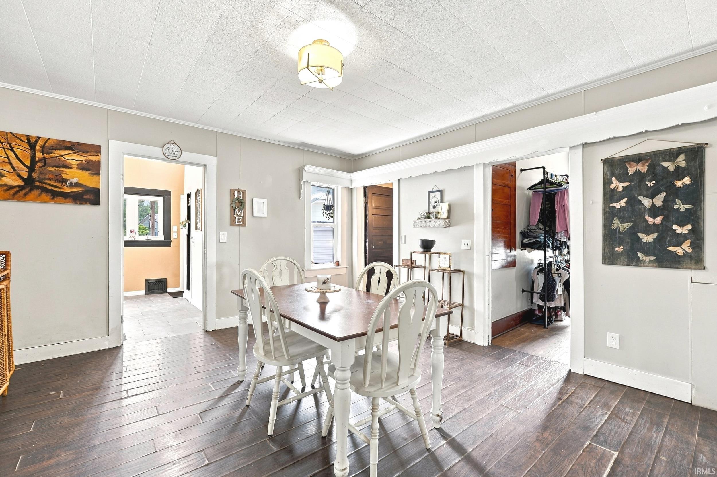 Spacious room featuring dark wood-finish flooring and light-toned walls