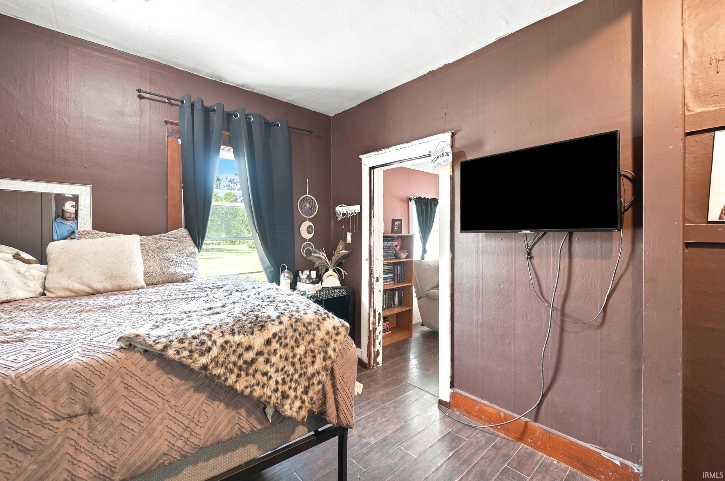 Interior room featuring wood-finish flooring and a window with exterior views