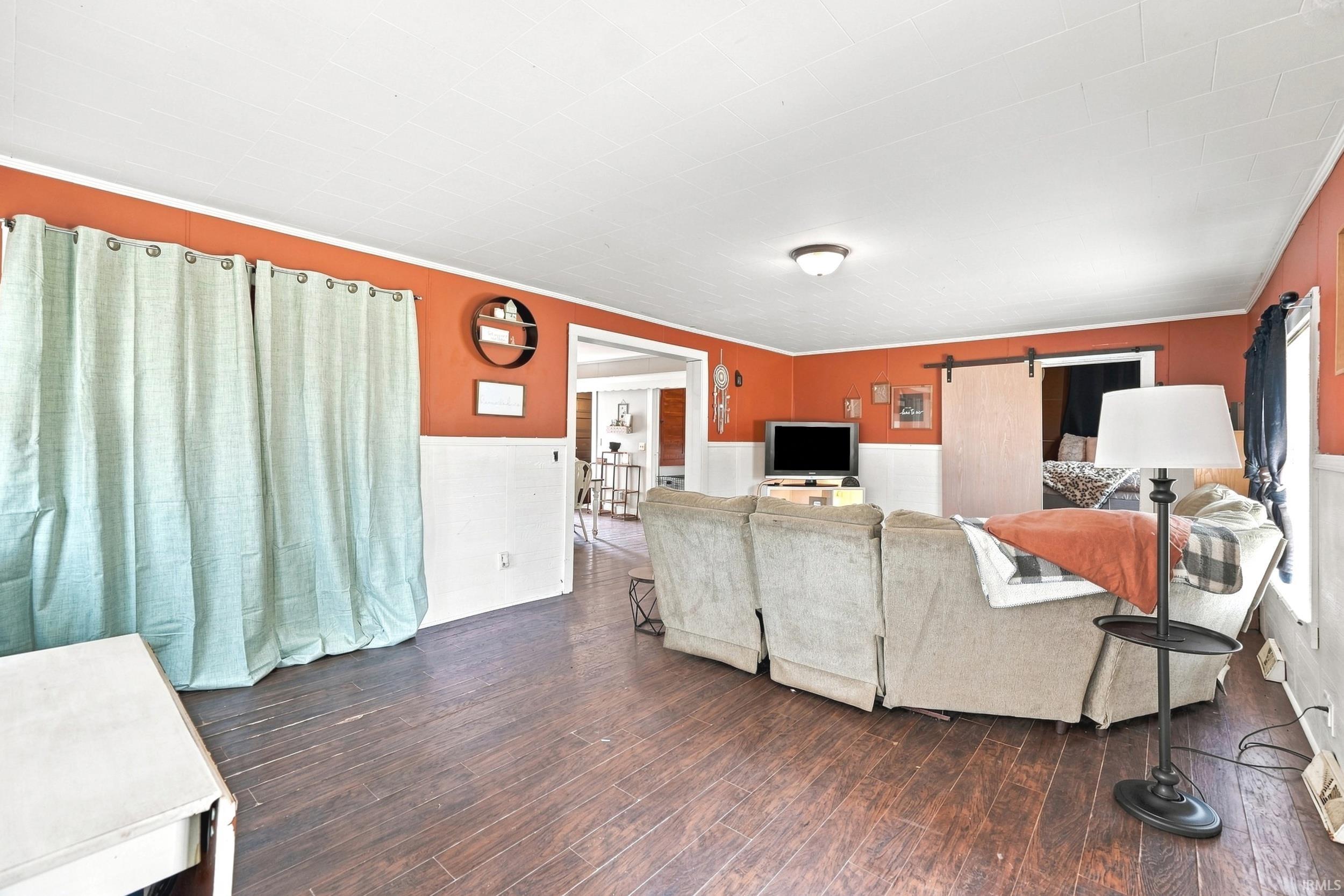 Living area with wood-finish flooring and a white ceiling