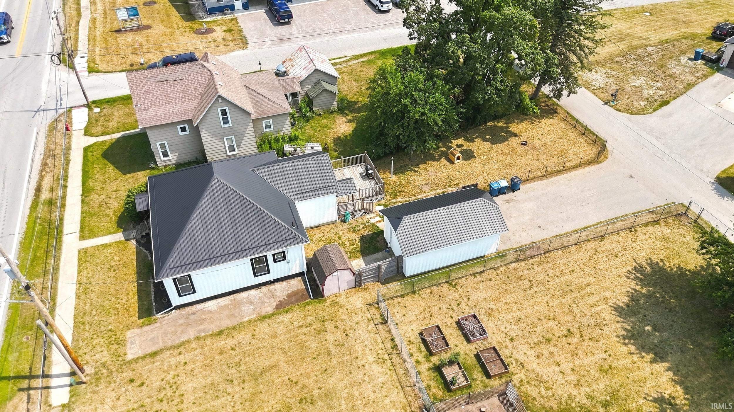 White exterior with black trim windows and a dark metal roof