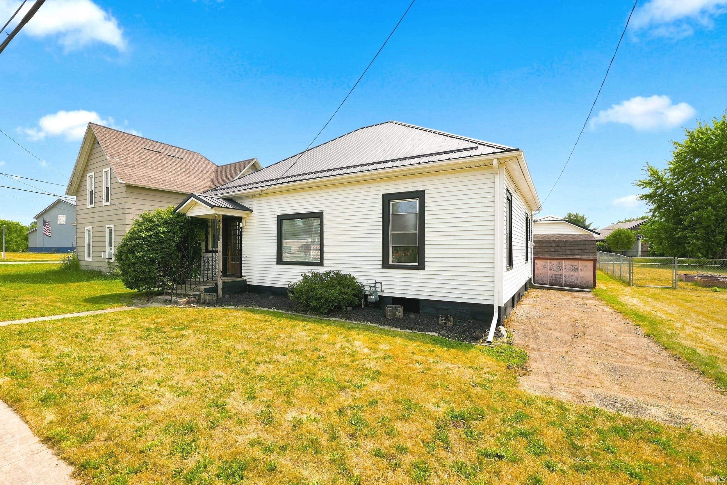 White siding exterior with black trim windows