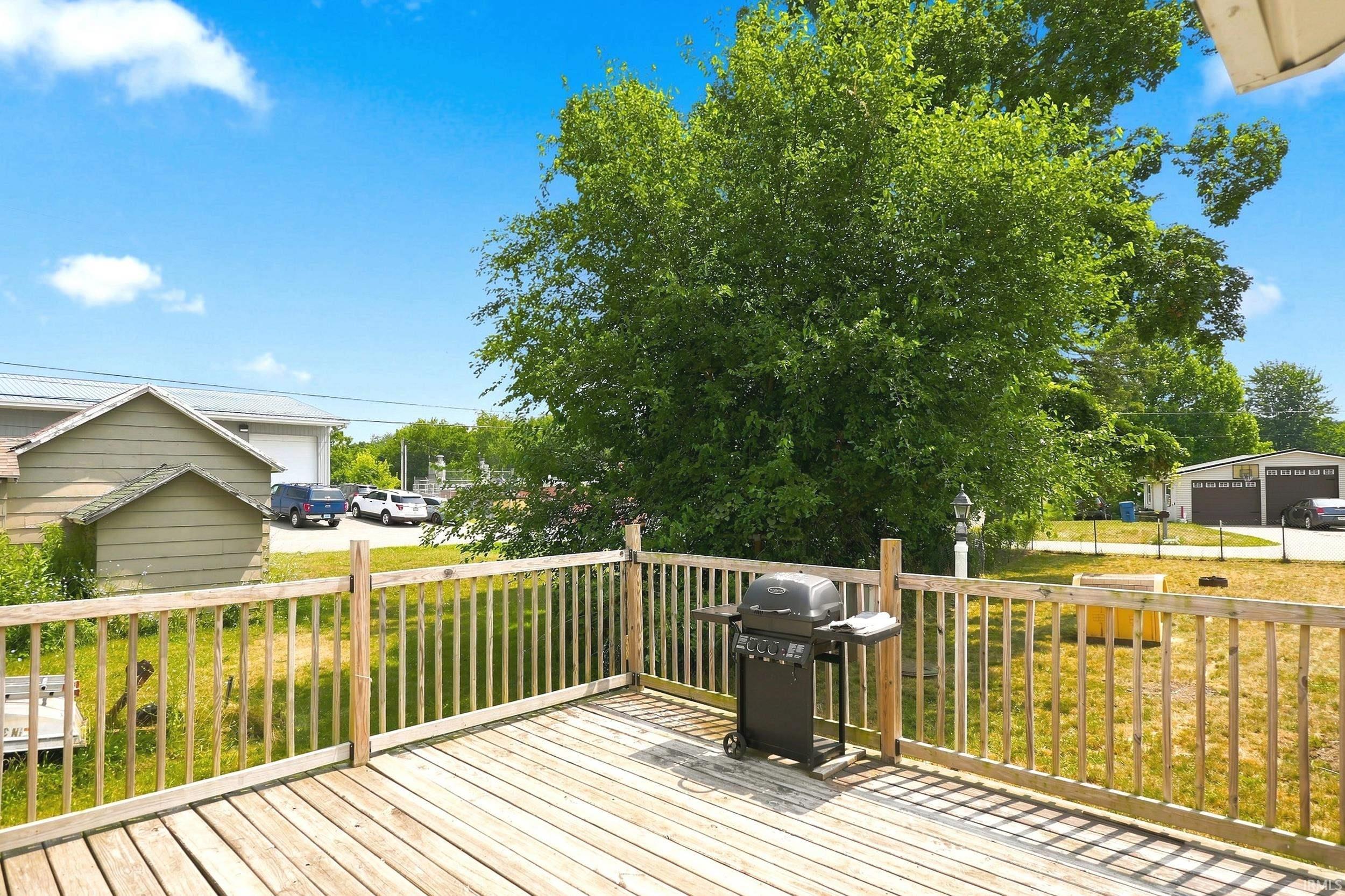 Expansive wood-finish deck with full wood railing