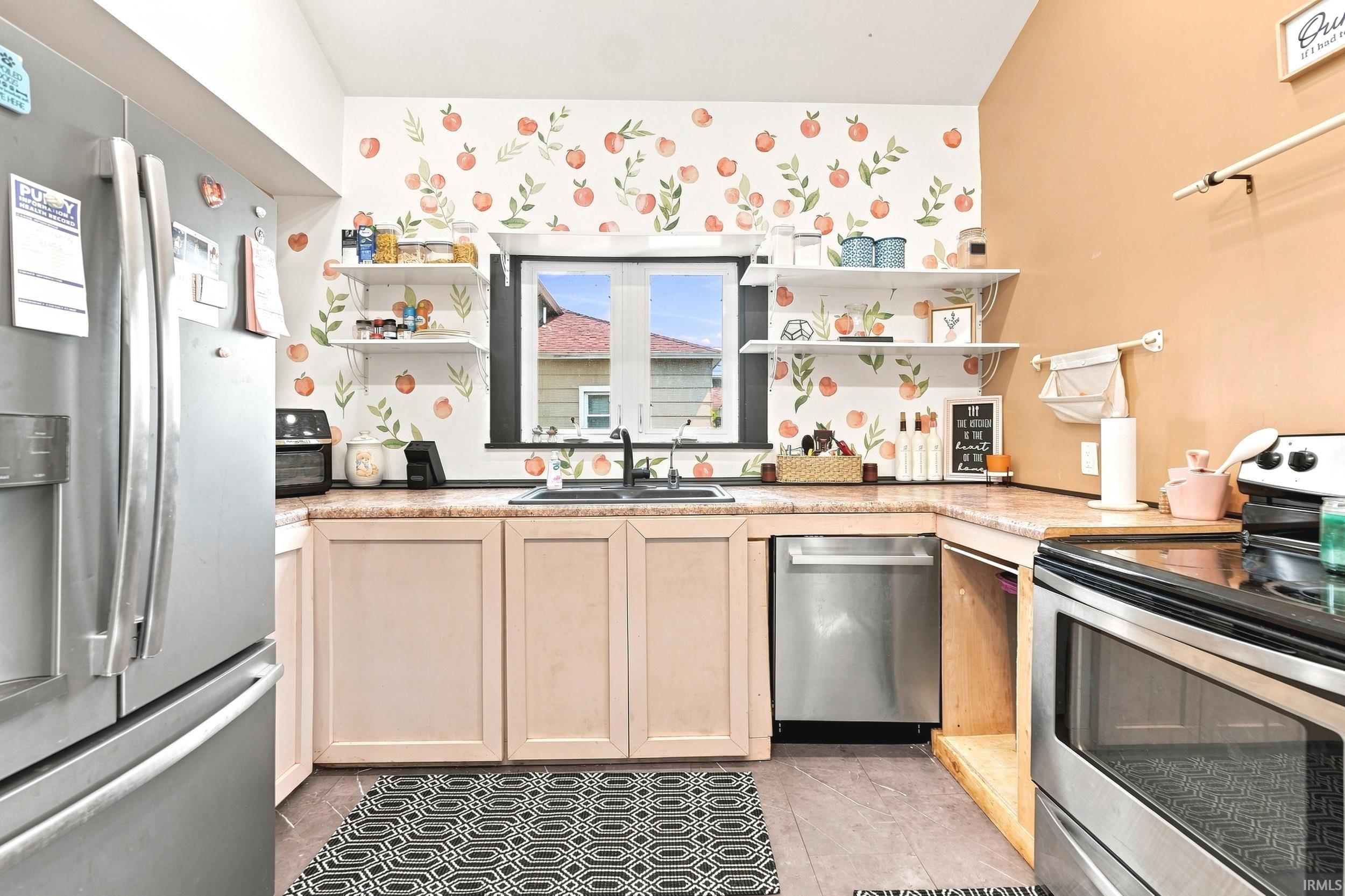 Kitchen featuring a black sink and faucet, stainless steel appliances, and open shelving