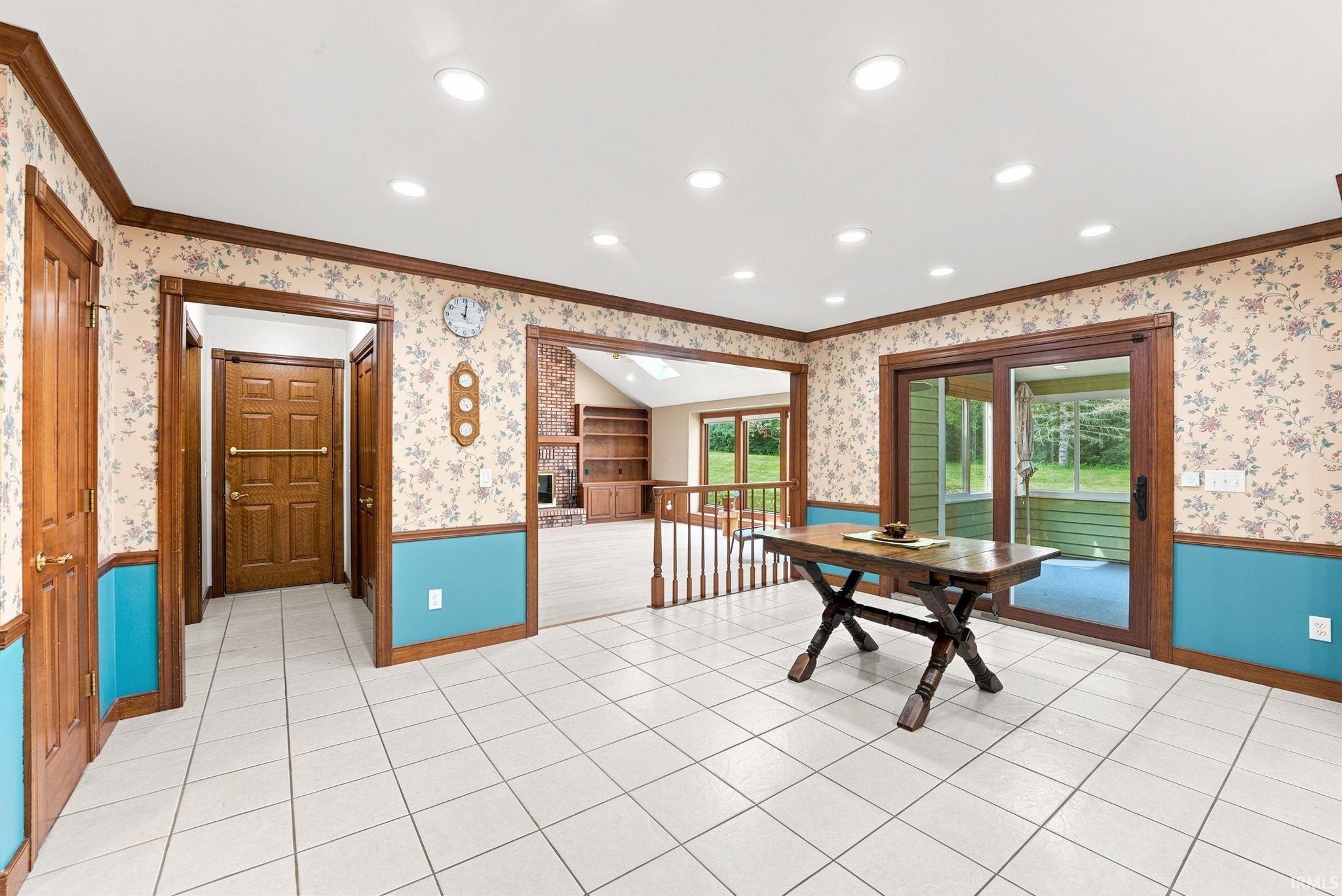 Spacious room featuring square tile flooring, recessed lighting, and rich wood trim