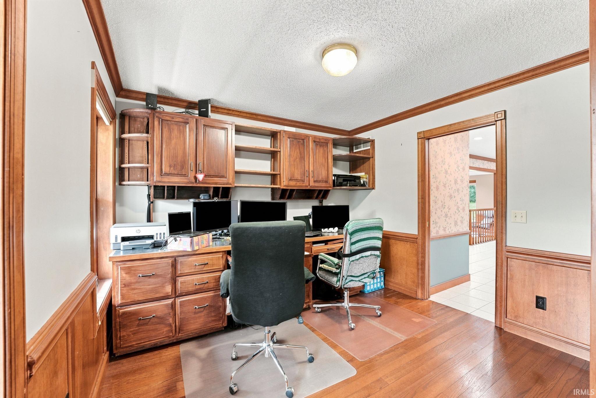 Built-in wood cabinetry and desk featuring multiple storage drawers