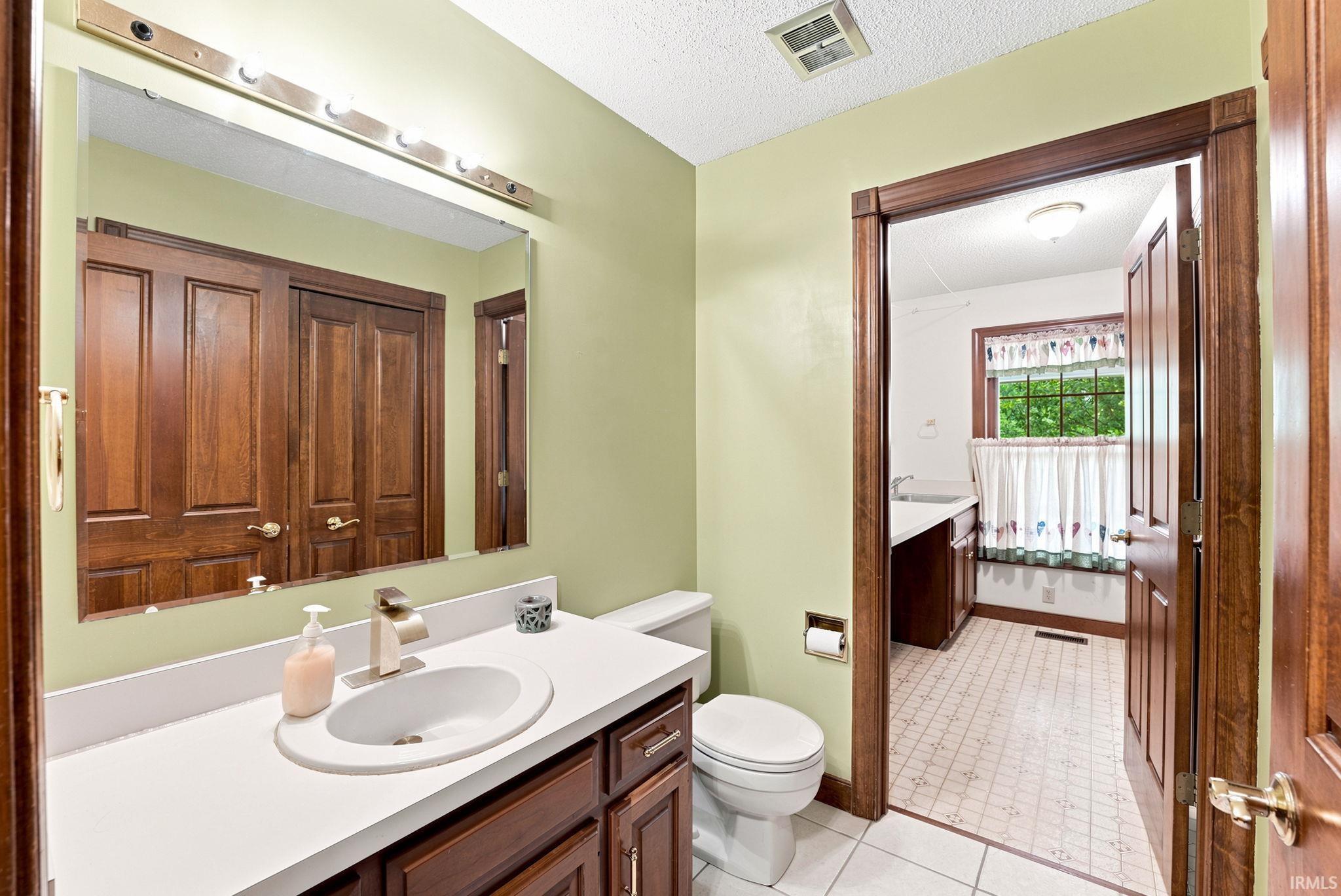 Bathroom featuring a white vanity with an undermount sink and a brushed nickel faucet