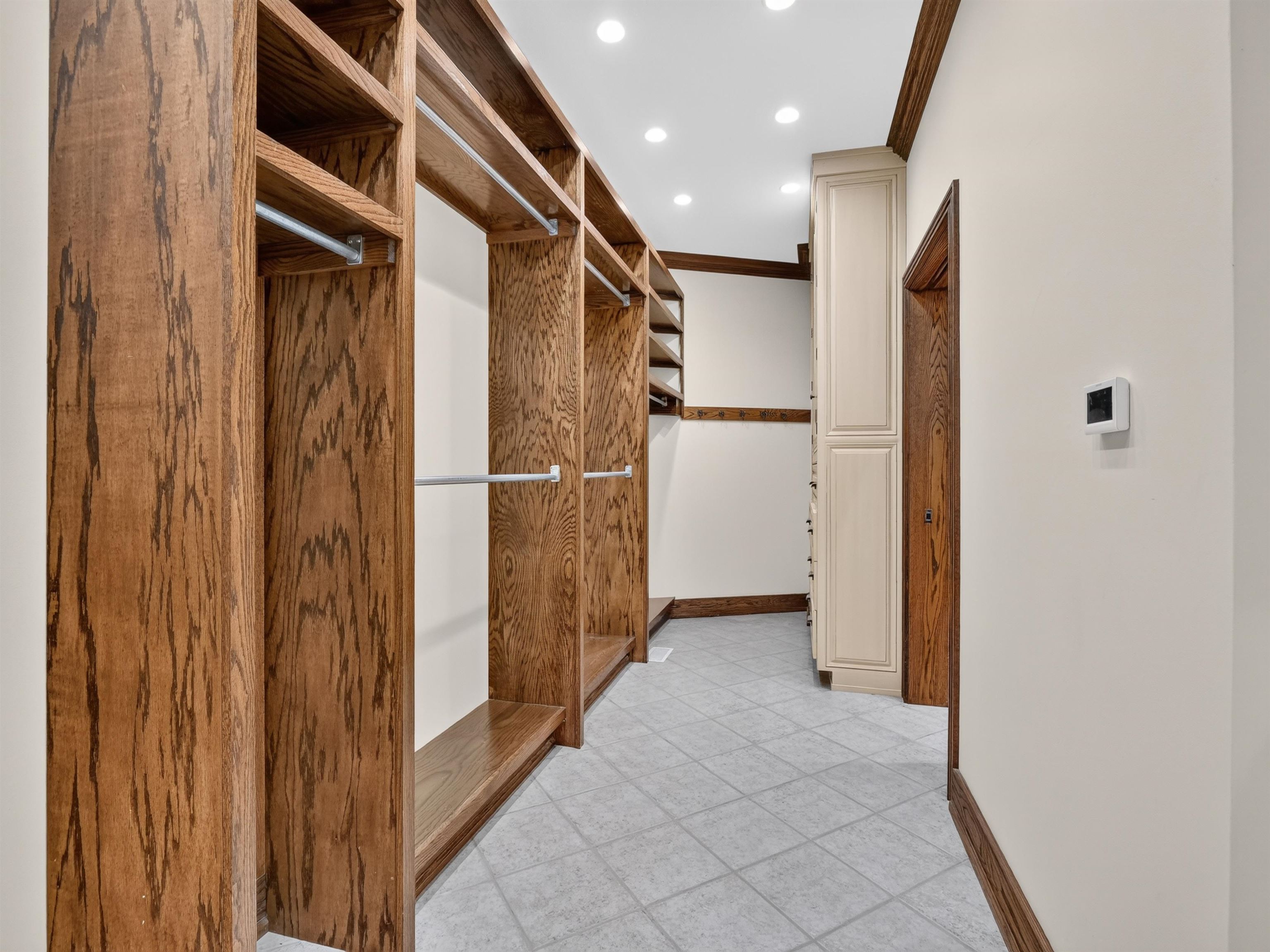 Custom wood-finish closet system featuring integrated shelving and hanging rods