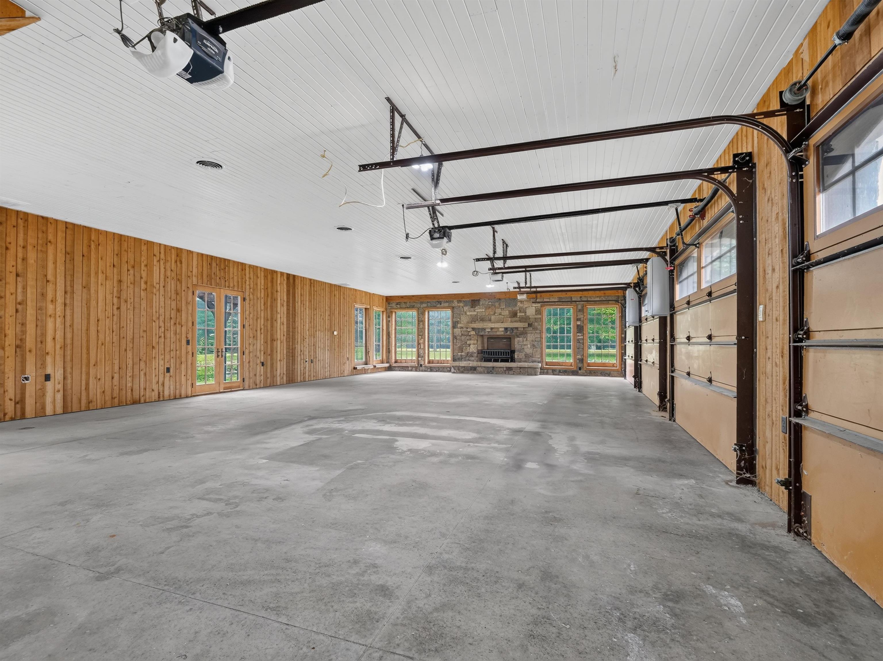Spacious interior with concrete flooring and wood paneling