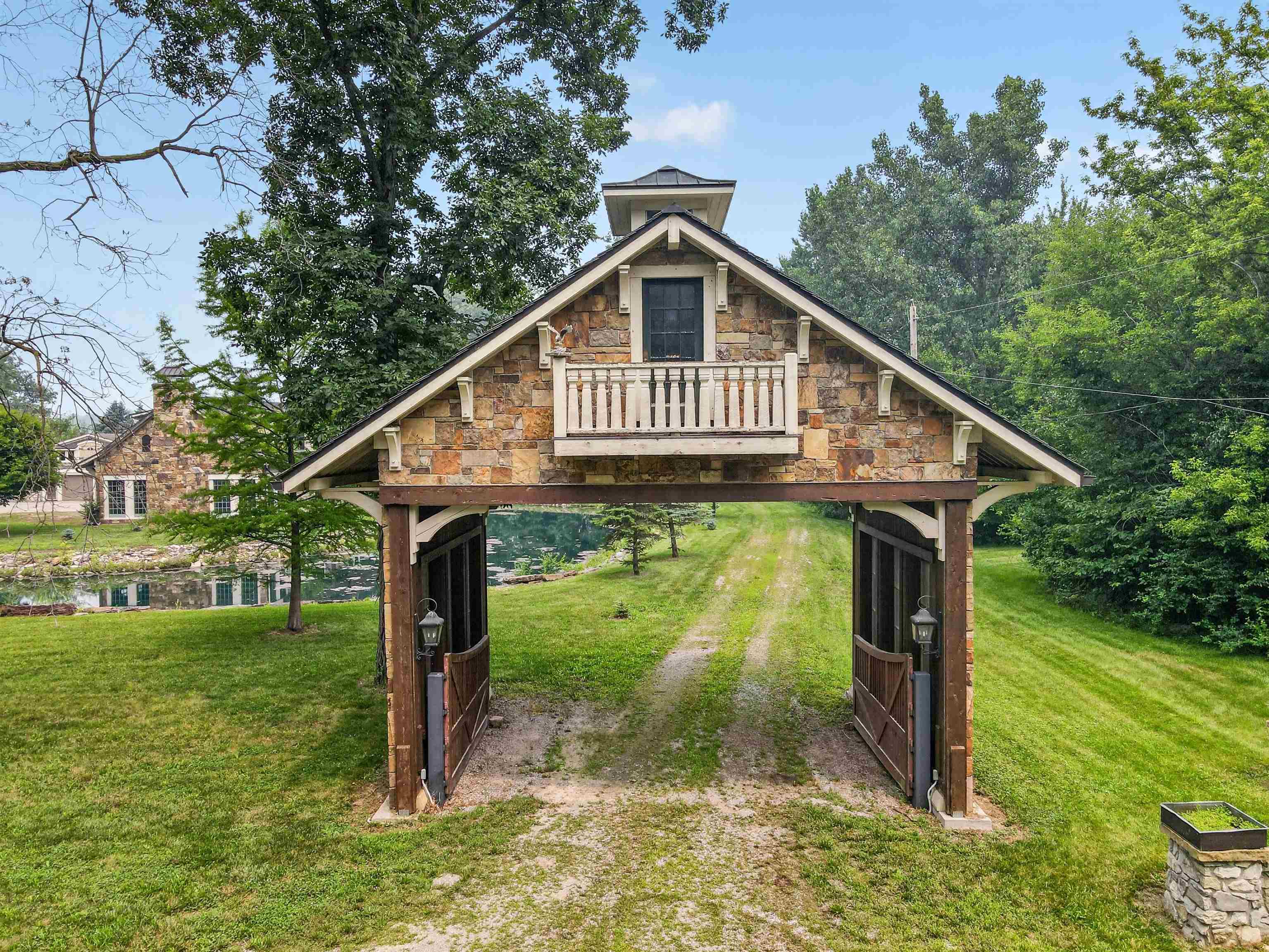 Stone and timber entry structure with a second-story balcony