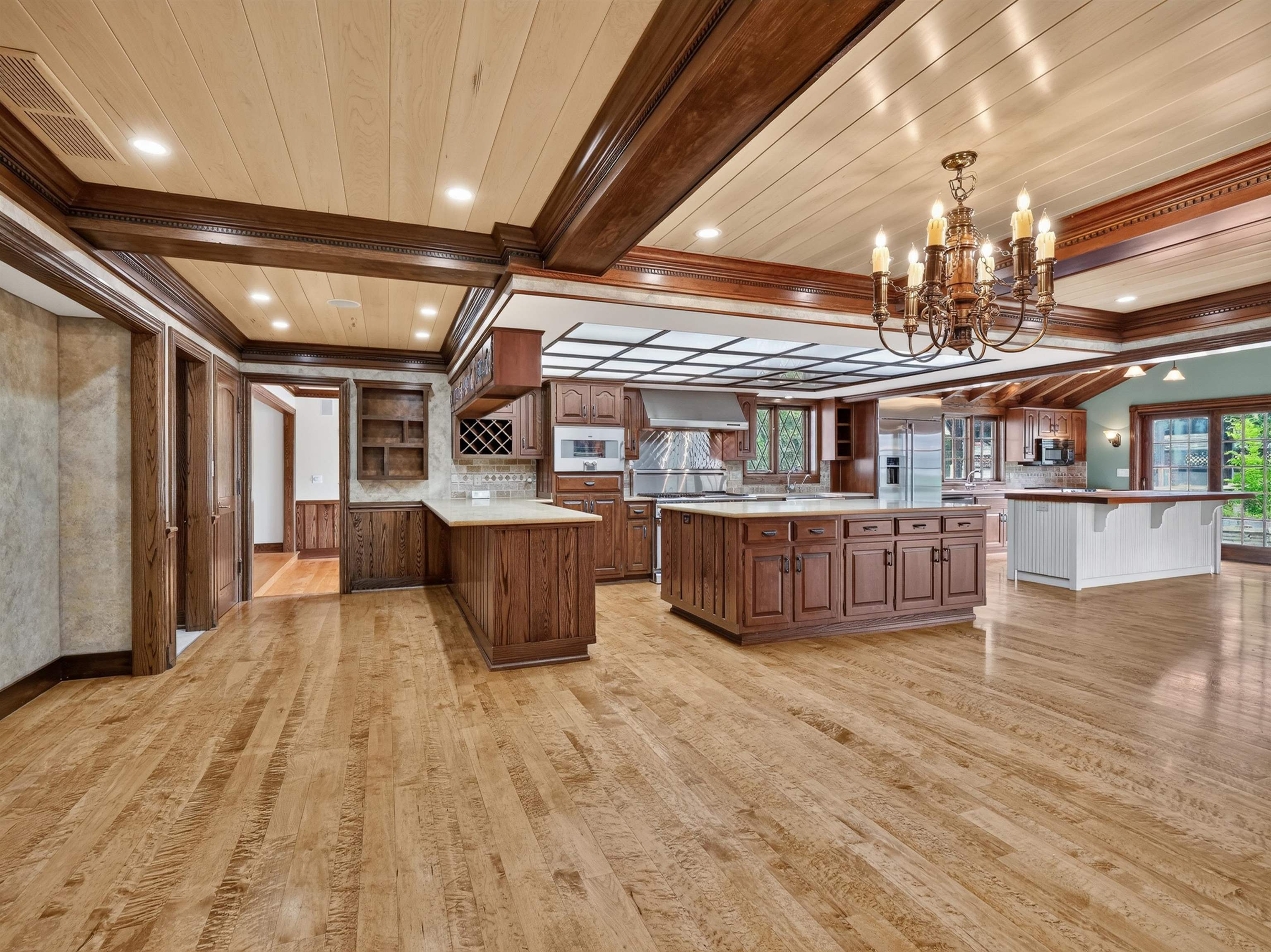 Spacious kitchen area featuring extensive wood-finish flooring