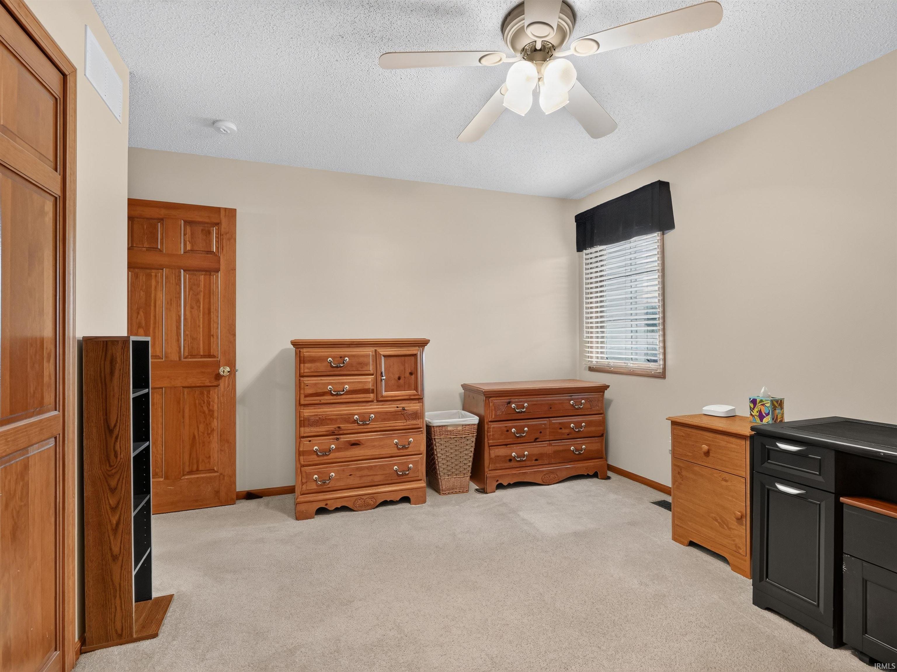 Neutral tone walls with carpeted flooring