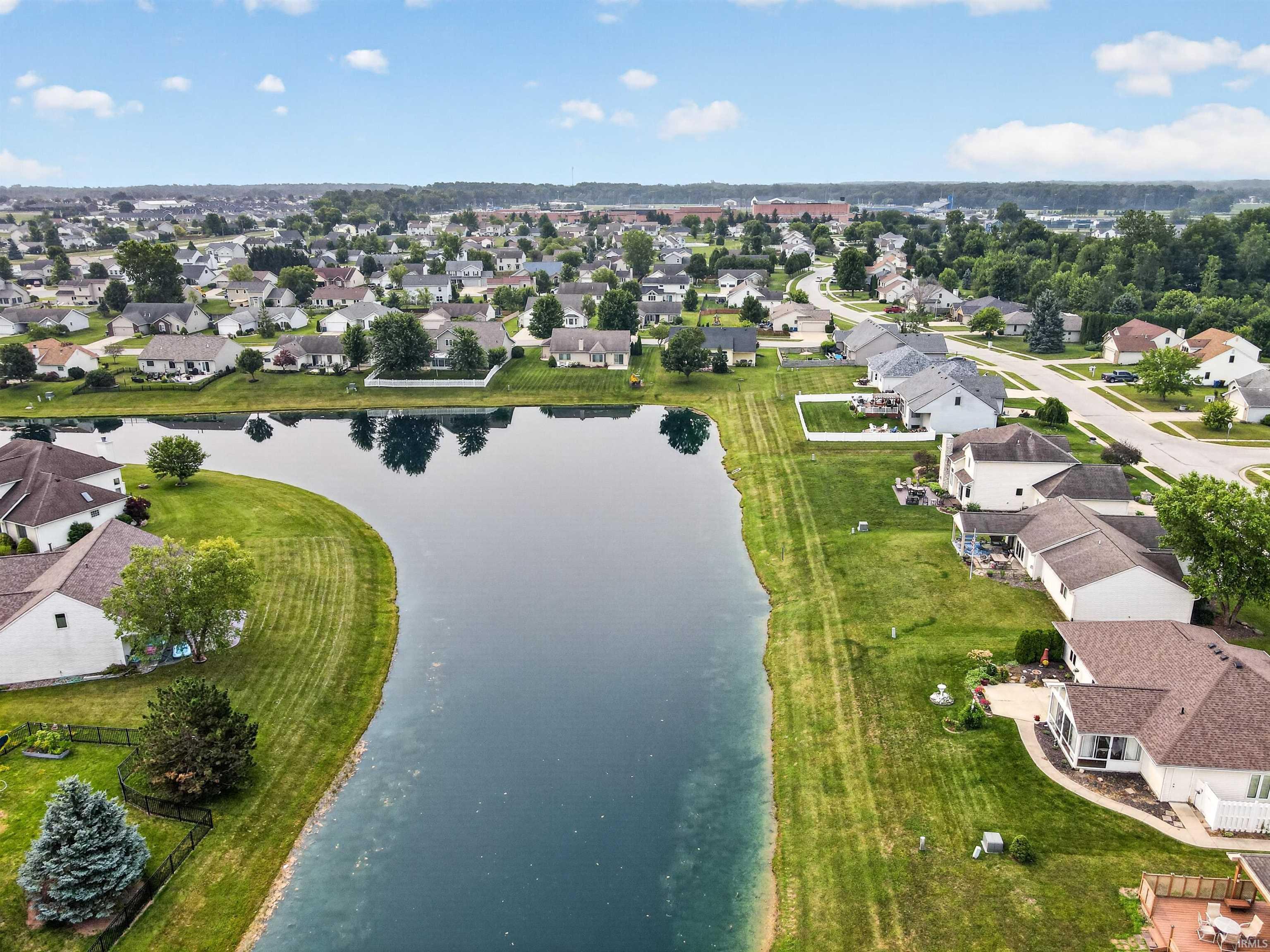 Aerial perspective showcasing a residential area with a prominent body of water