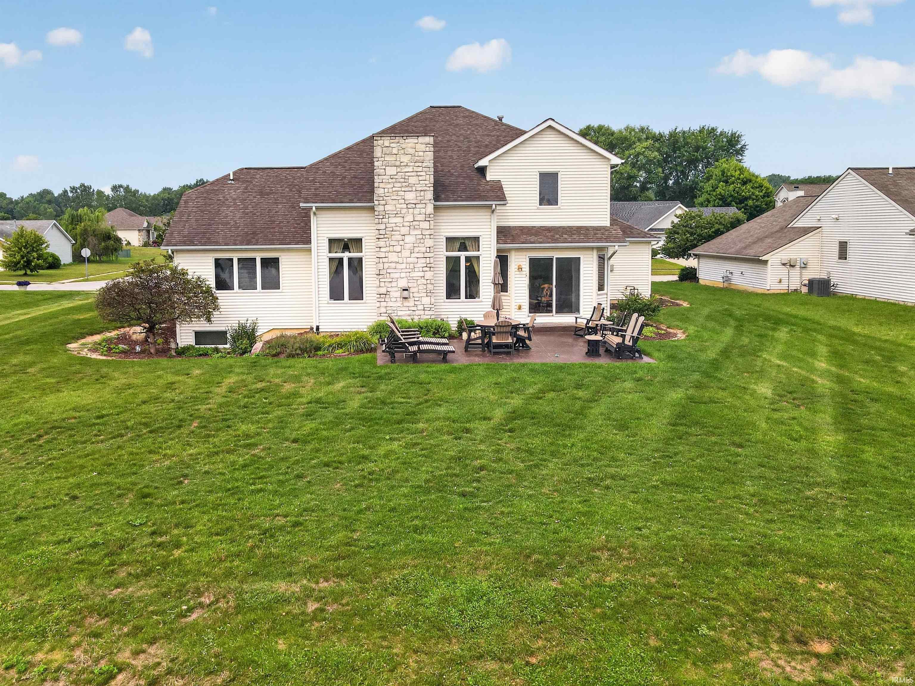 Expansive green lawn with a large rear patio