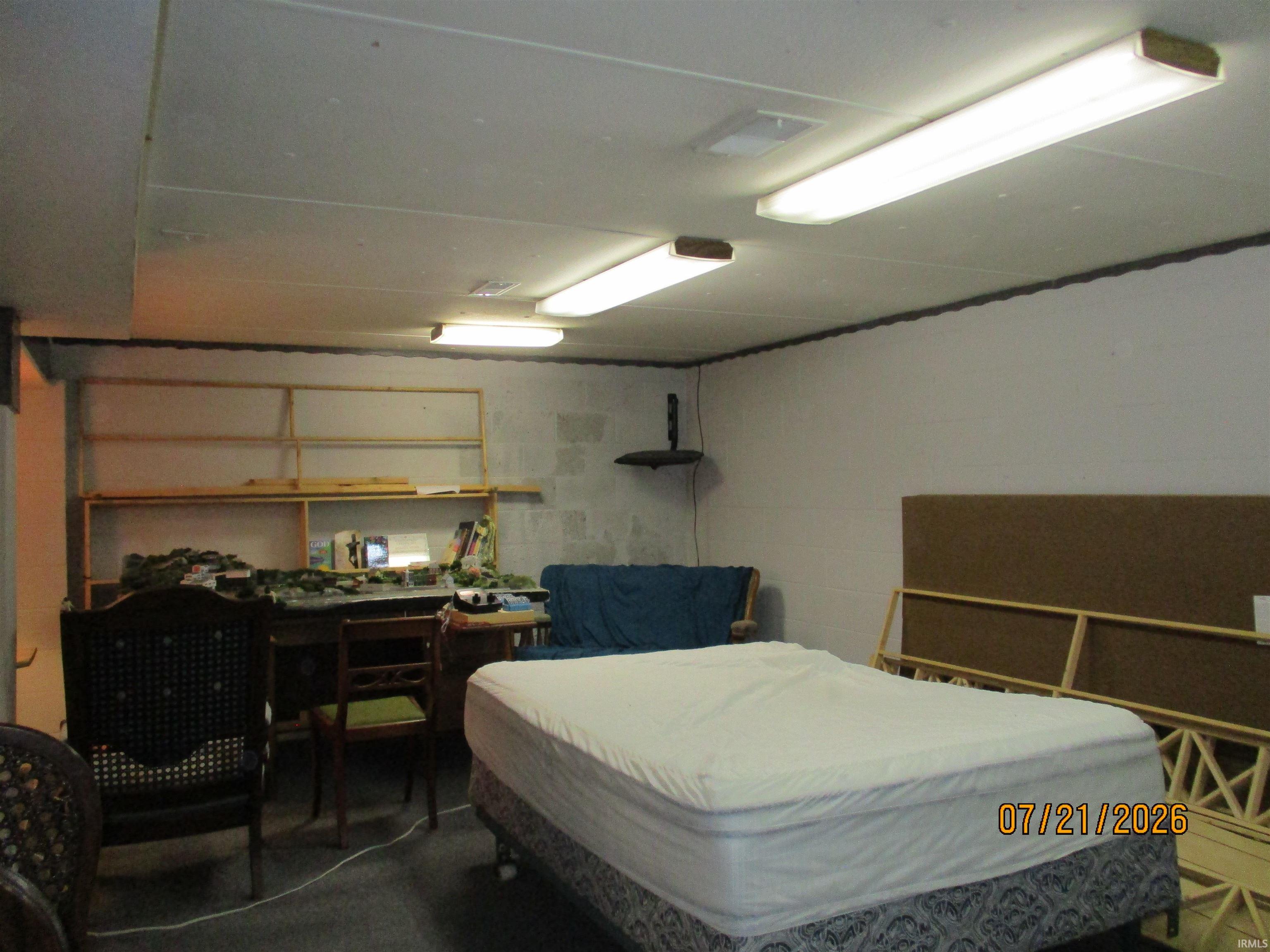 Room featuring block wall construction and overhead fluorescent lighting