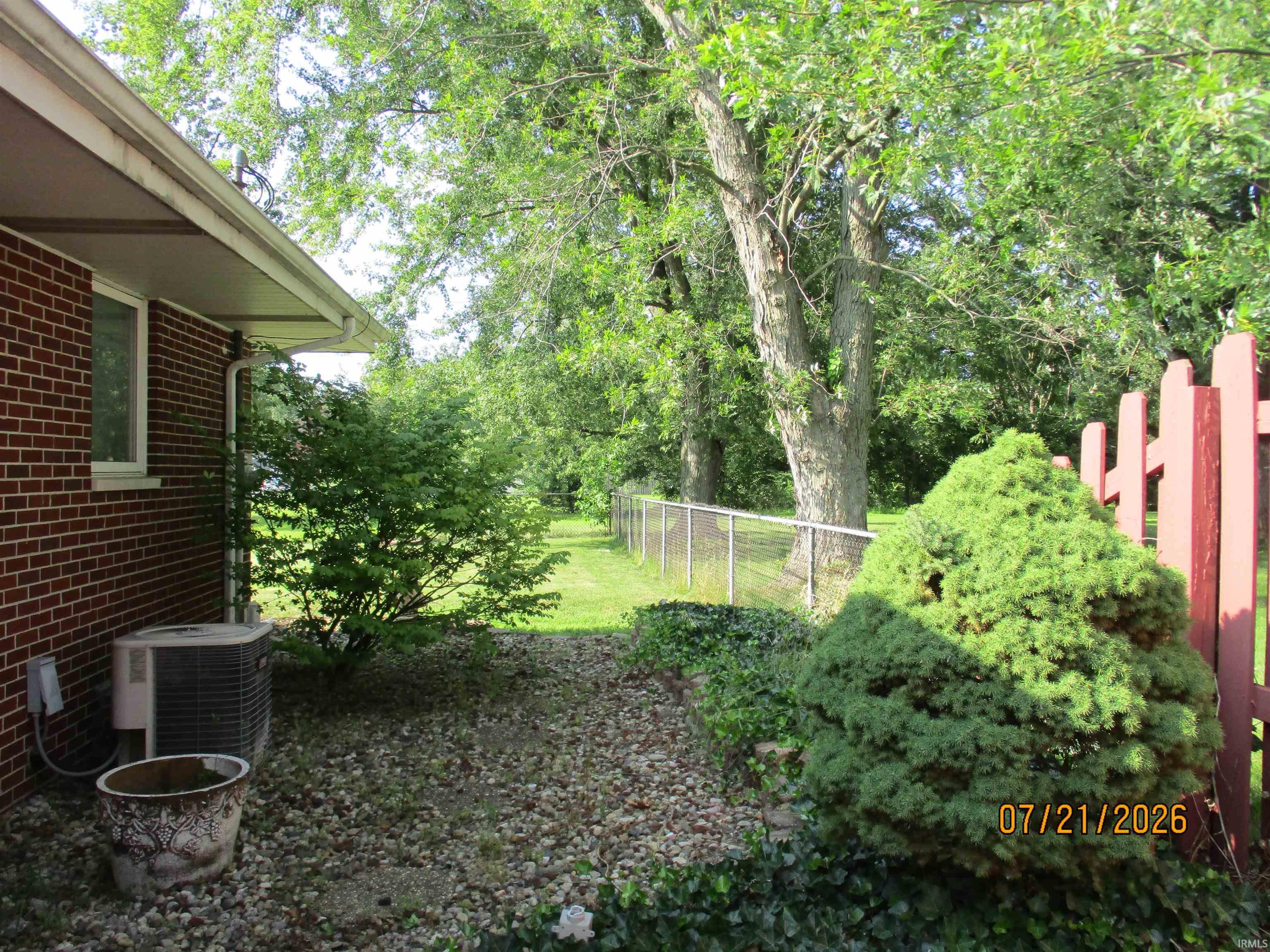Exterior brick siding with white window trim and a covered soffit