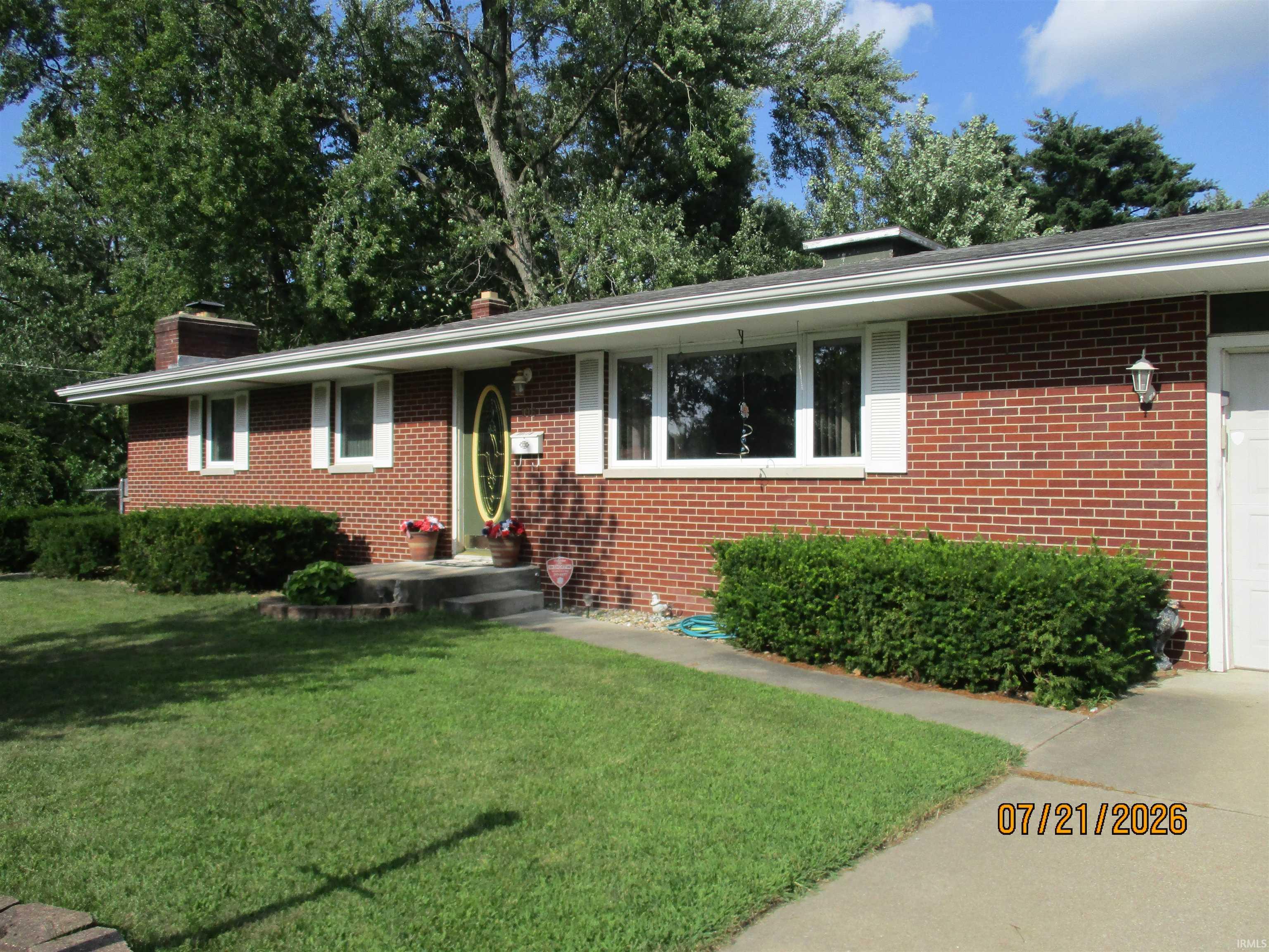 Brick exterior with white window trim and shutters