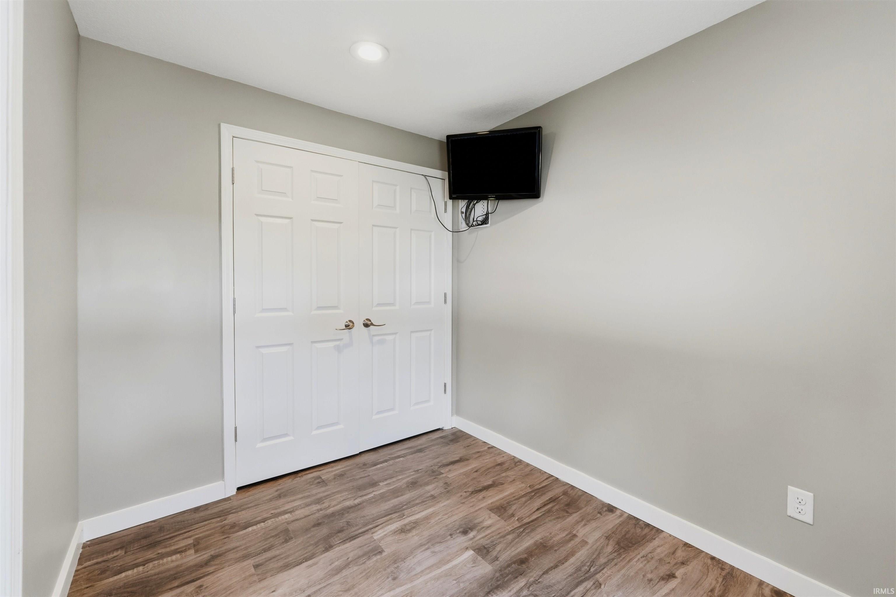 Neutral tone walls with white trim and wood-finish flooring