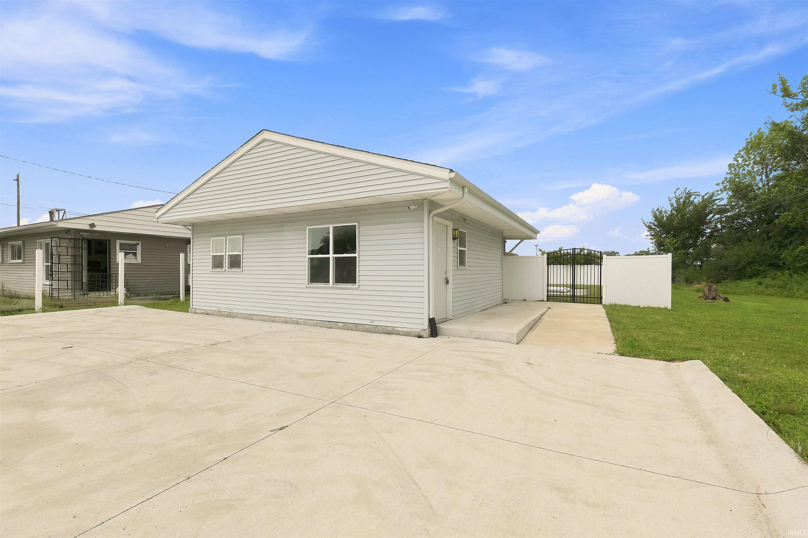 Light gray vinyl siding exterior with a pitched roofline