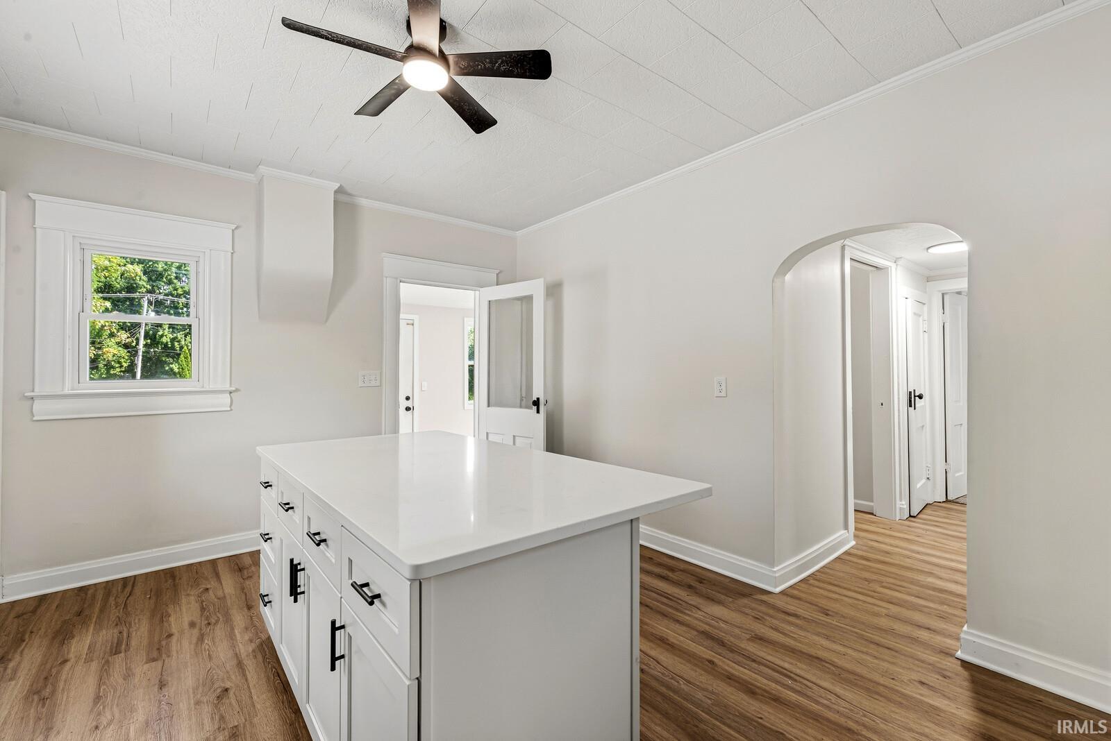 Central island with a solid surface countertop and matte black hardware