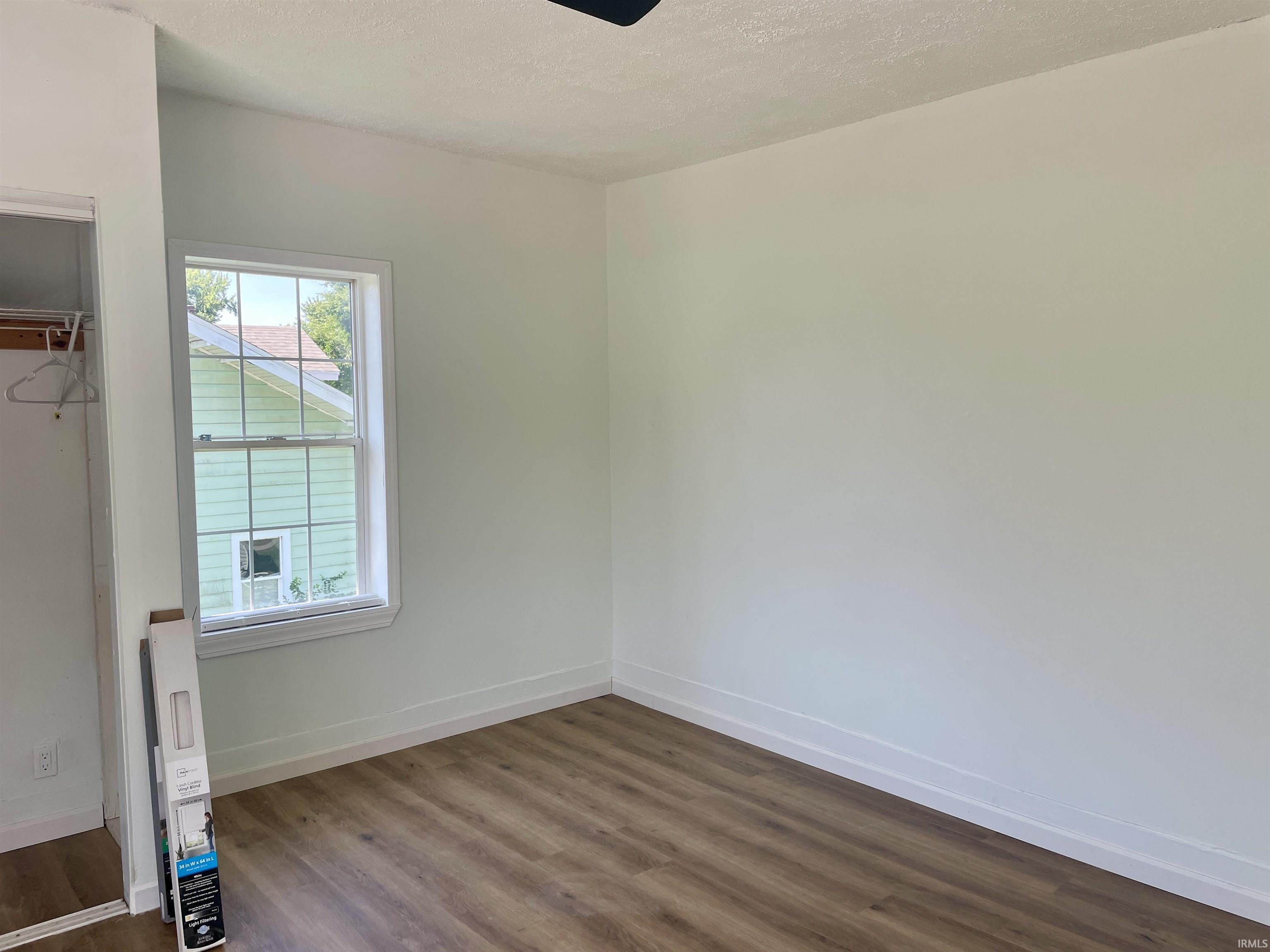 Neutral wall tones with wood-finish flooring