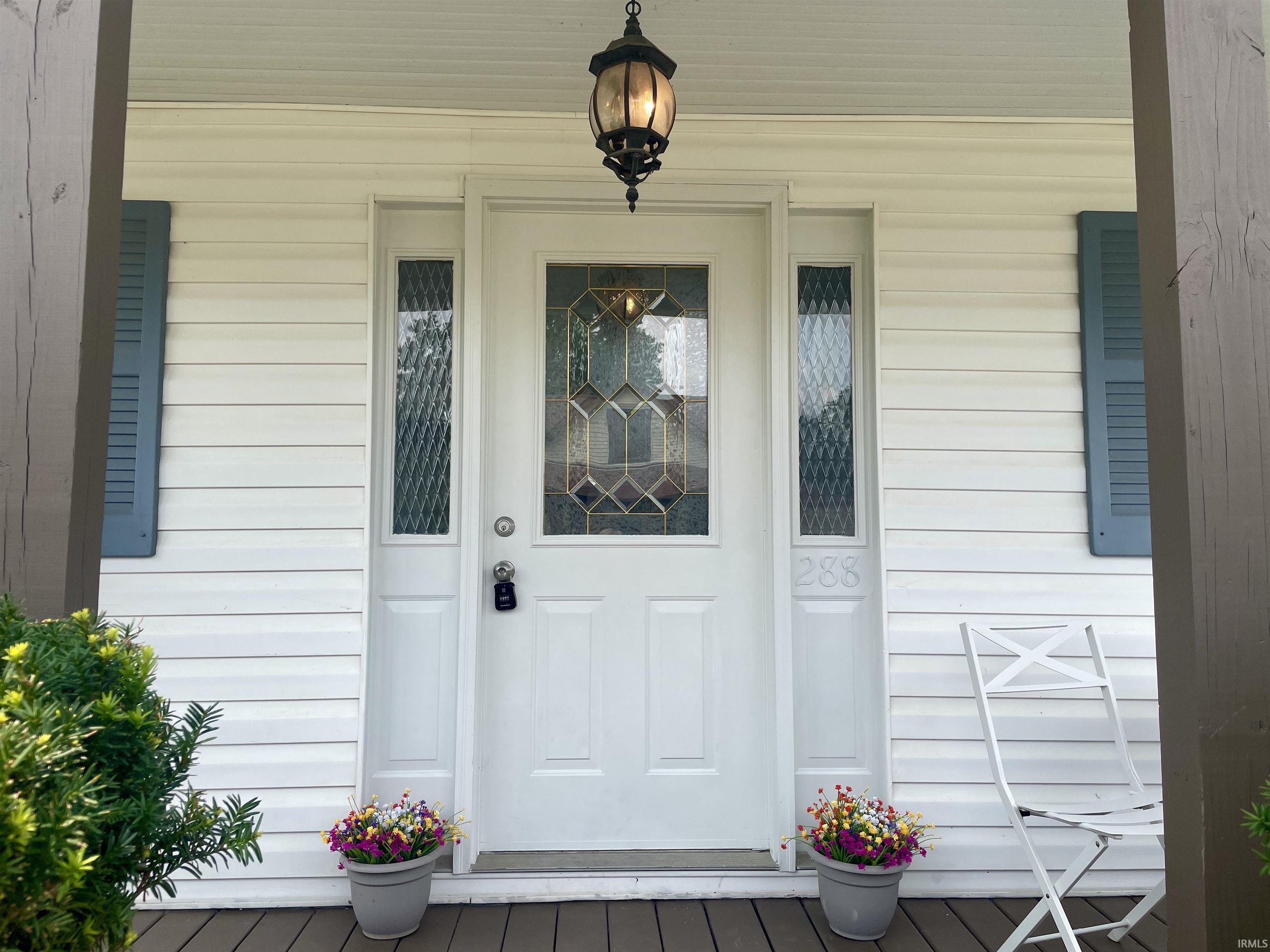 White paneled siding exterior with decorative blue shutters