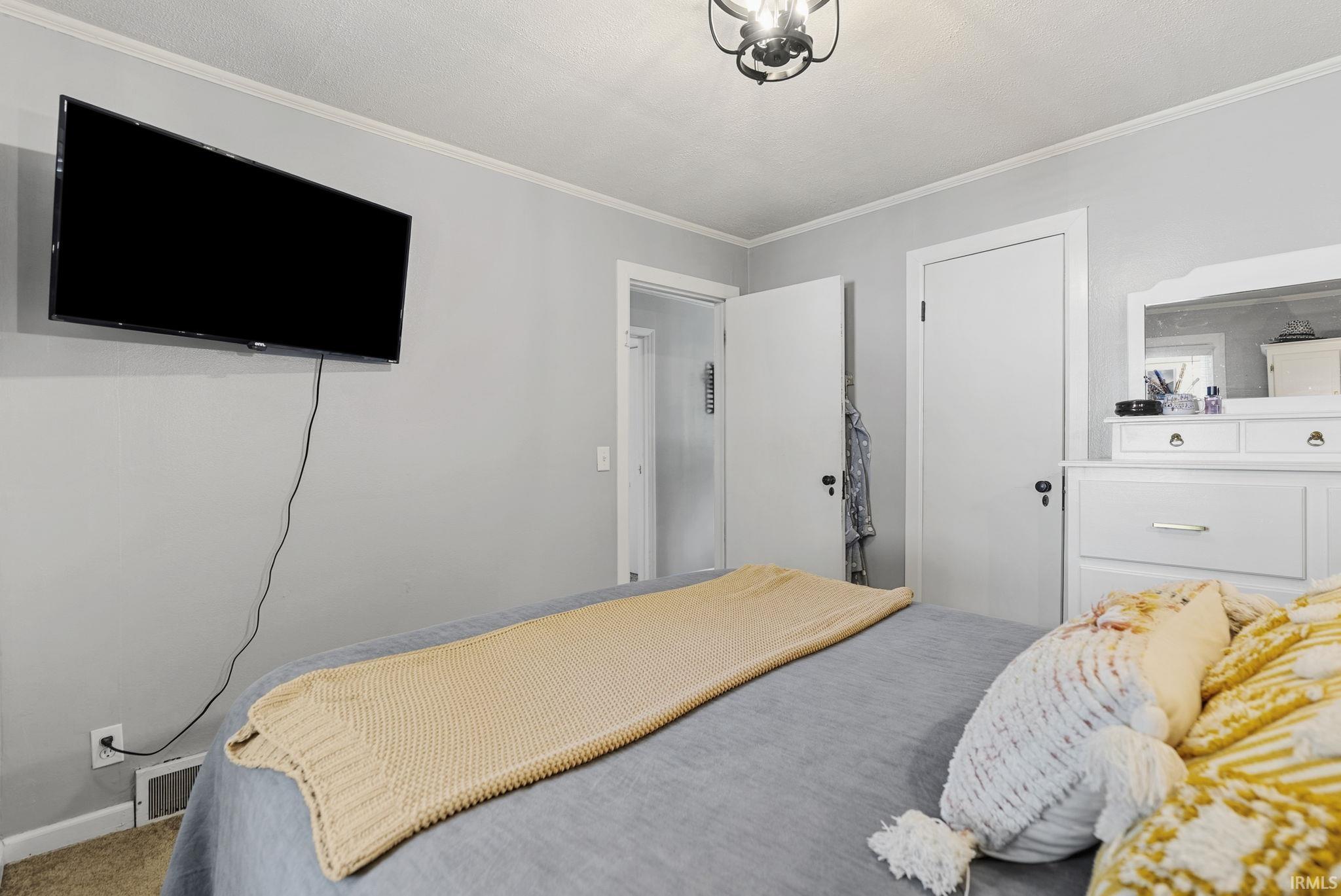 Room featuring light gray walls, white trim, and a ceiling-mounted light fixture