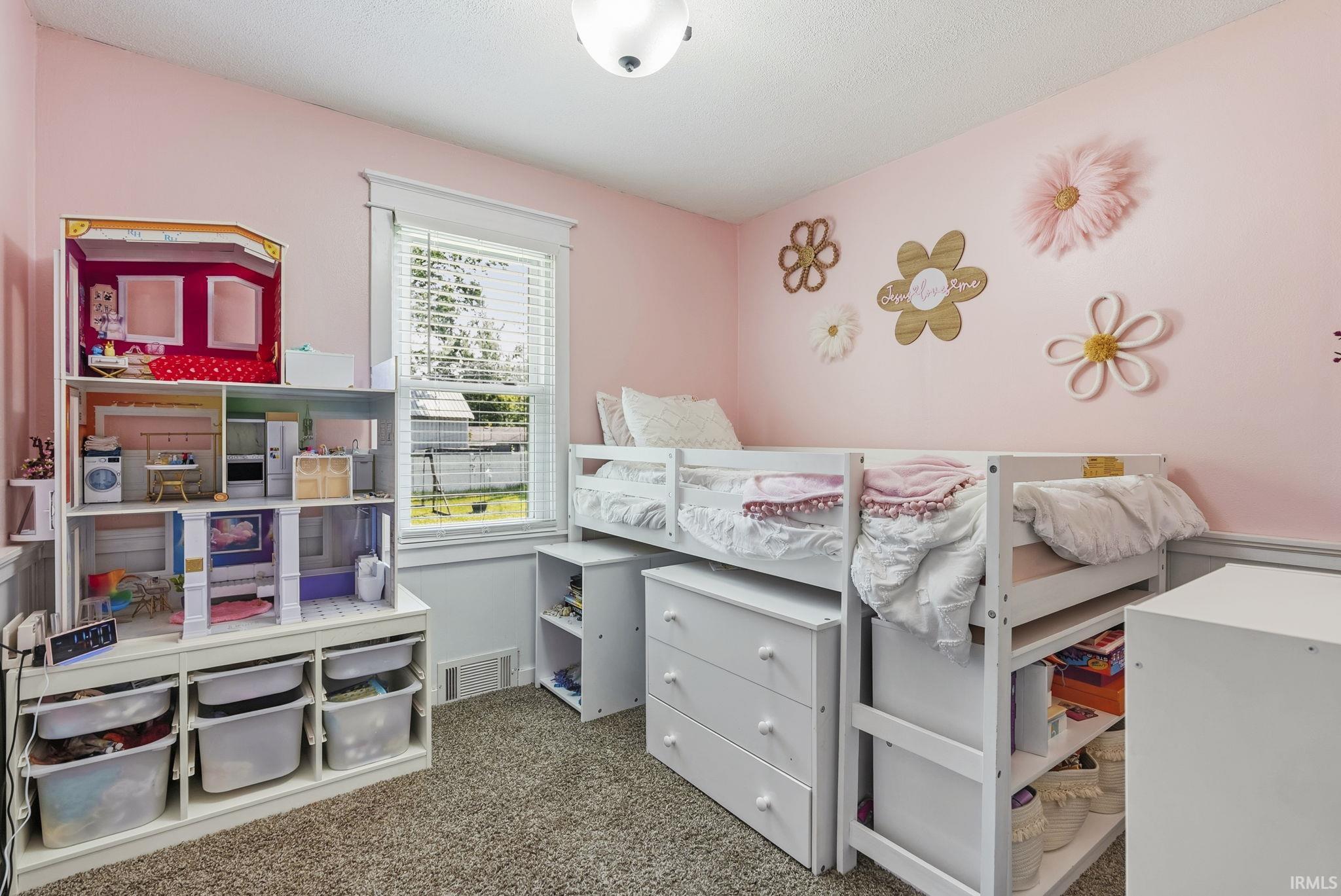 Carpeted room with pink painted walls and white trim