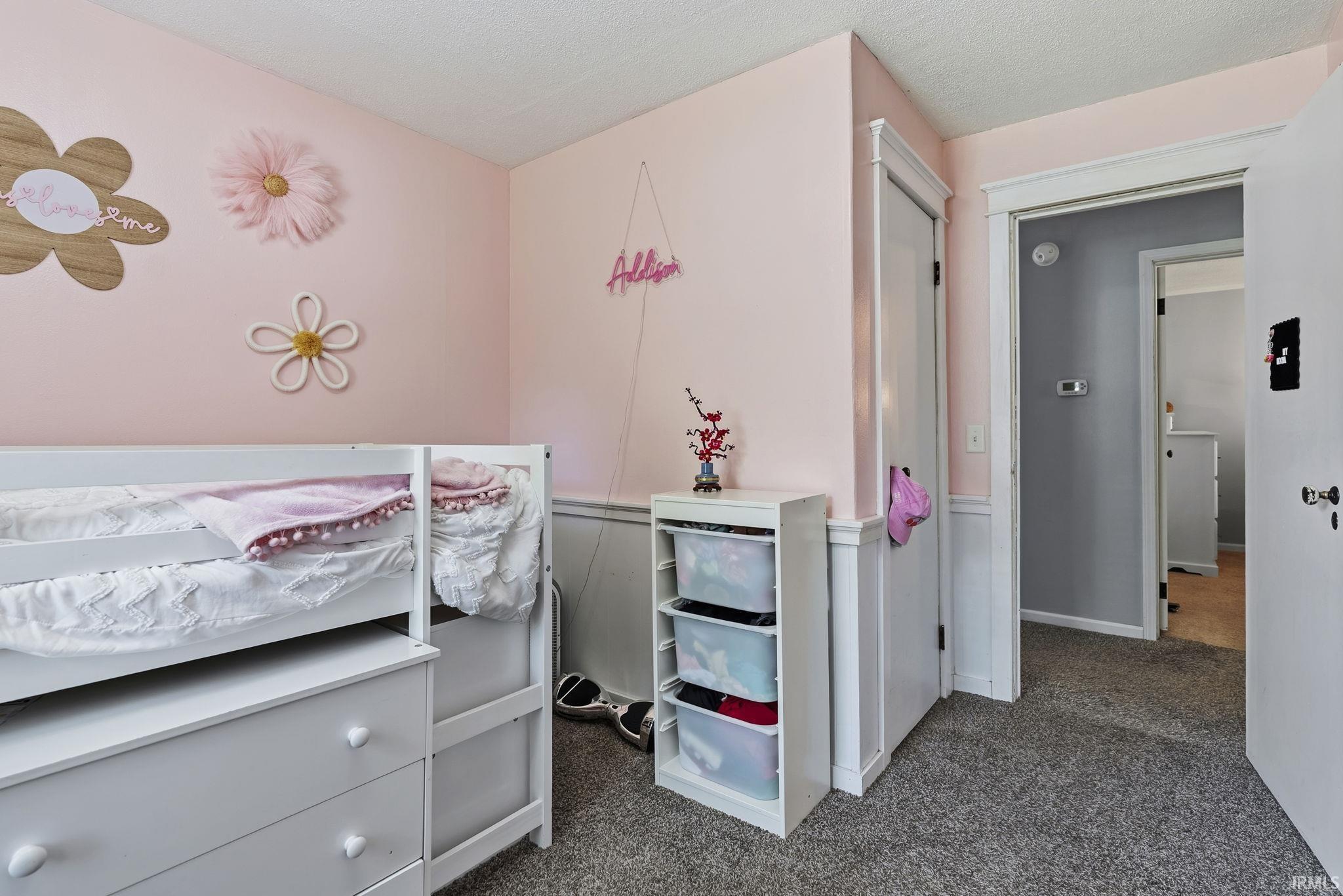 Light pink wall paint complemented by white wainscoting and trim
