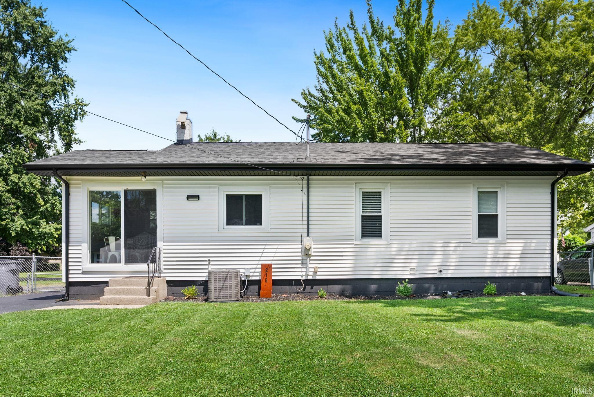 Manicured lawn complementing a white siding exterior