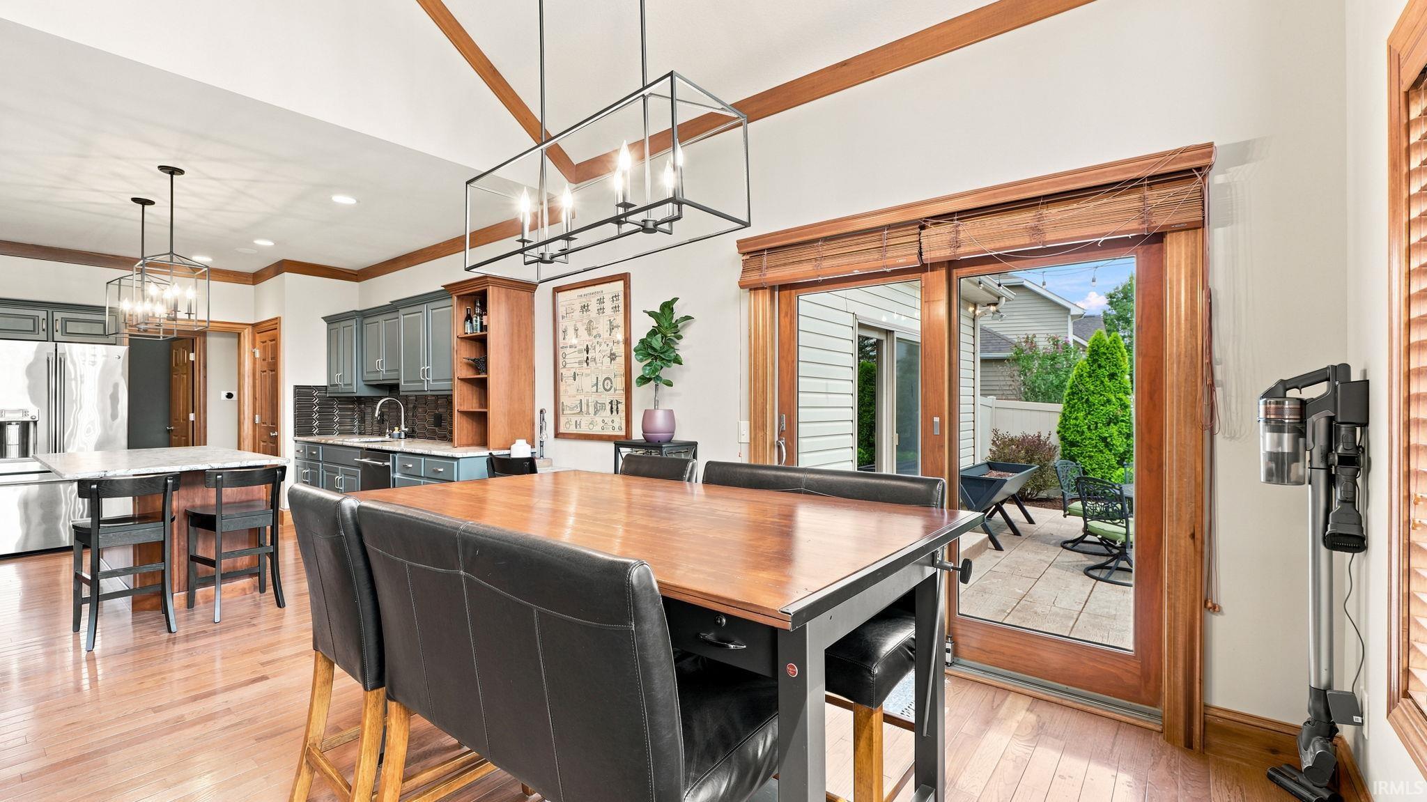 Vaulted ceilings with exposed wood beams complement the wood-finish flooring
