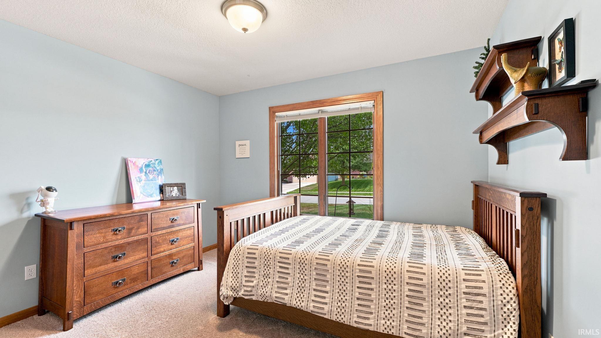 Light blue painted walls with a window featuring natural wood trim