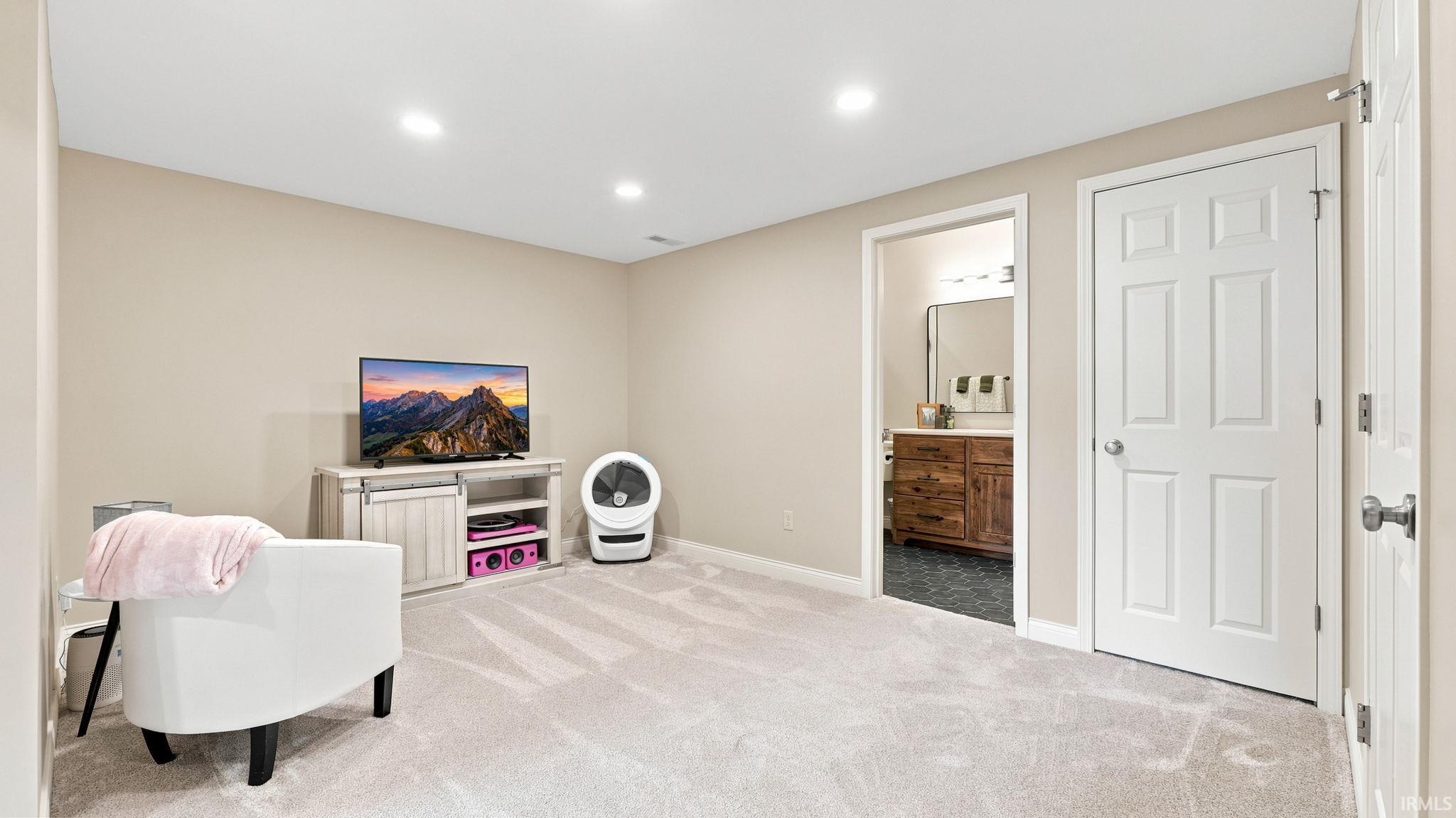 Spacious carpeted room featuring recessed lighting and neutral wall tones