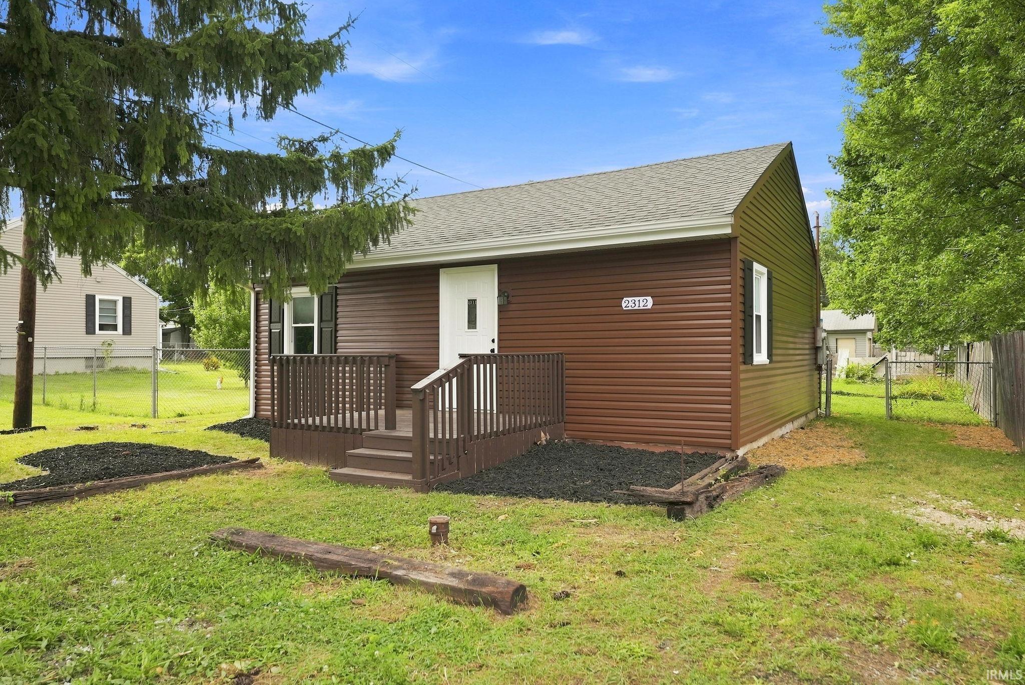 Brown horizontal siding exterior with a white entry door