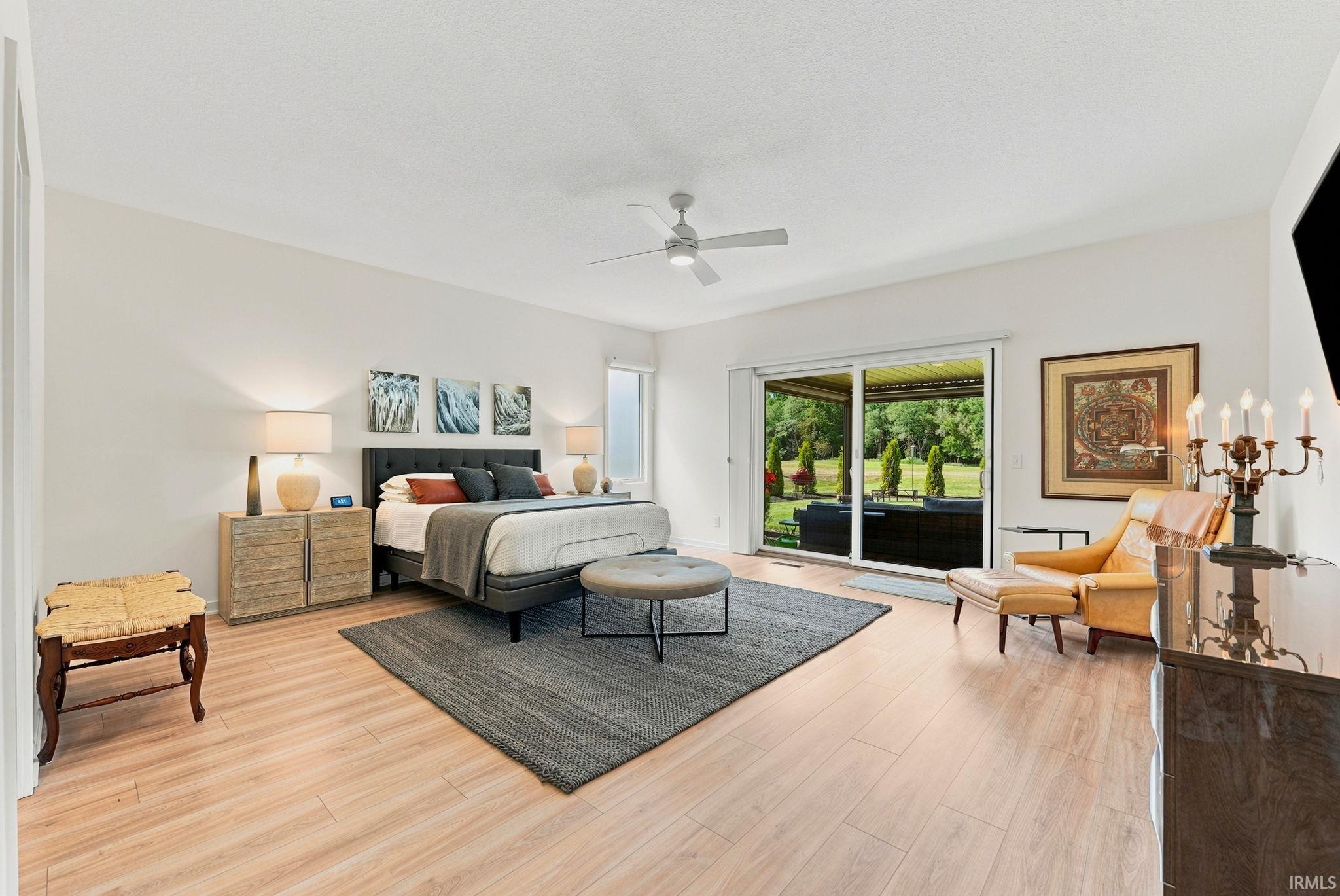 Spacious interior featuring light wood-finish flooring and a ceiling fan