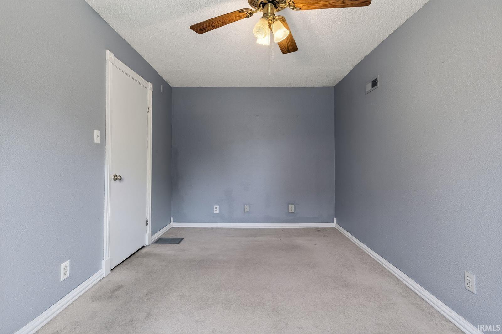 Room with gray textured walls and light-toned carpeting