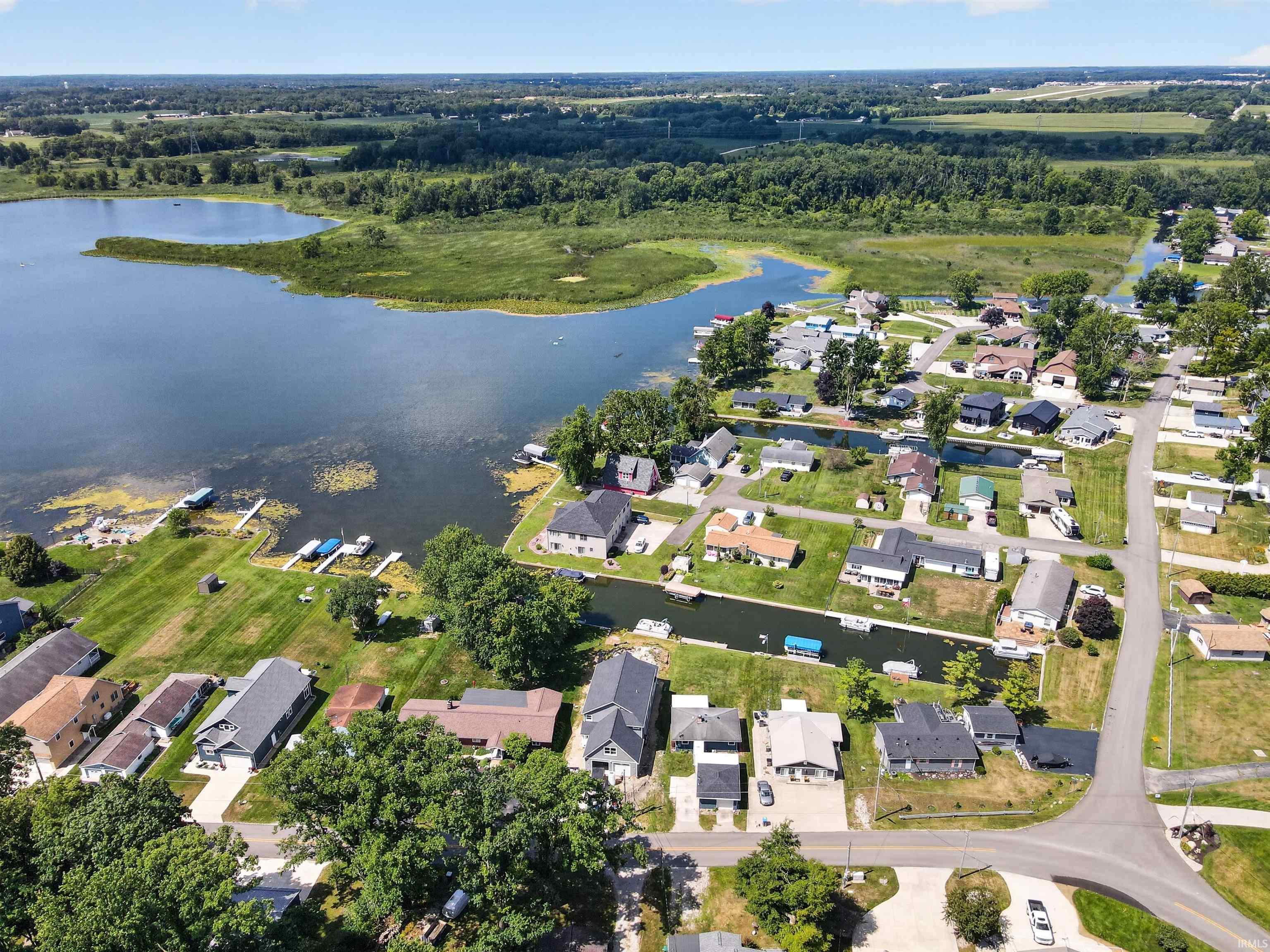 Expansive waterfront property featuring a substantial body of water, direct water access, and multiple private boat docks