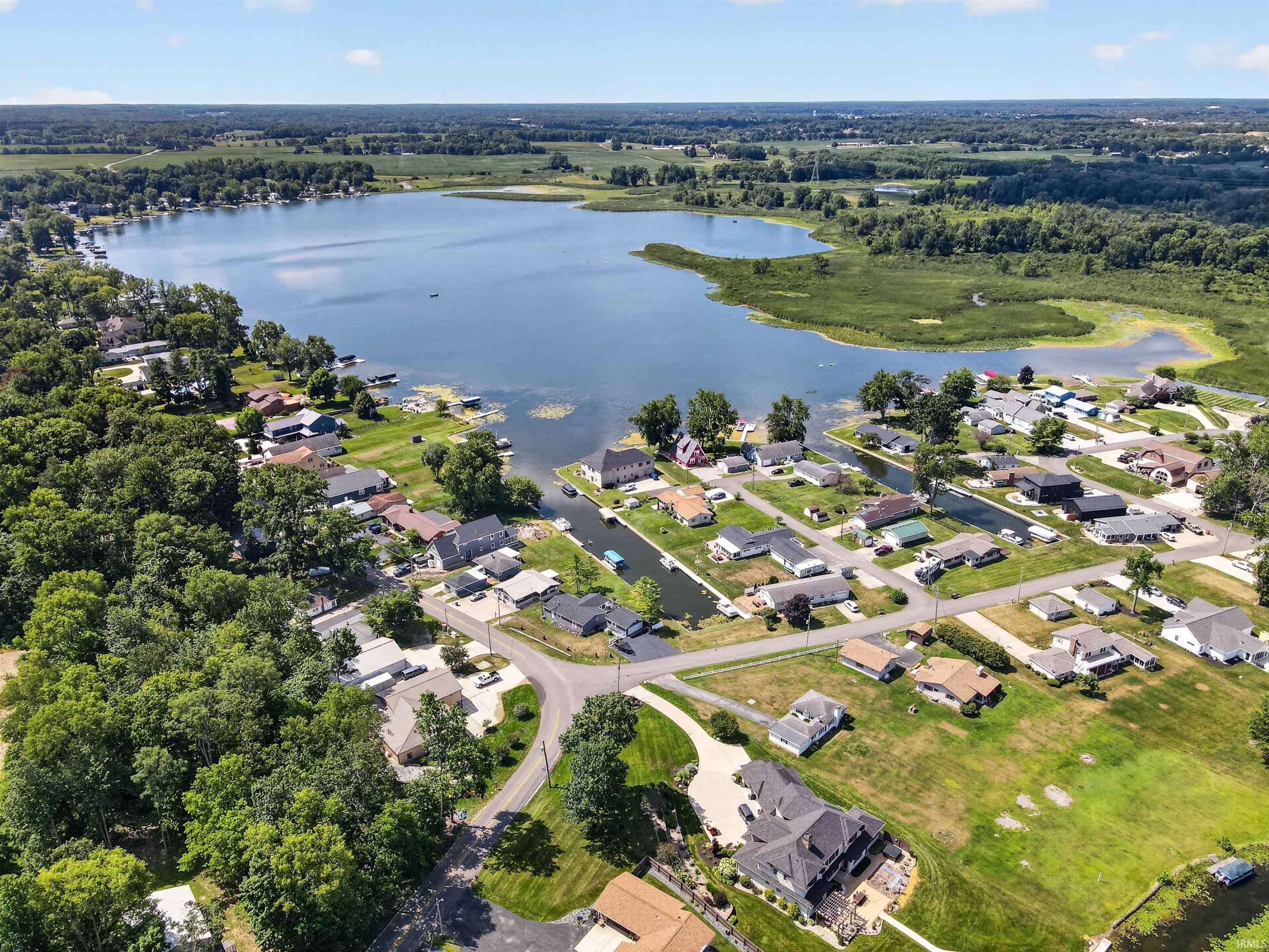 Aerial perspective showcasing a lakefront community with numerous properties featuring direct water access