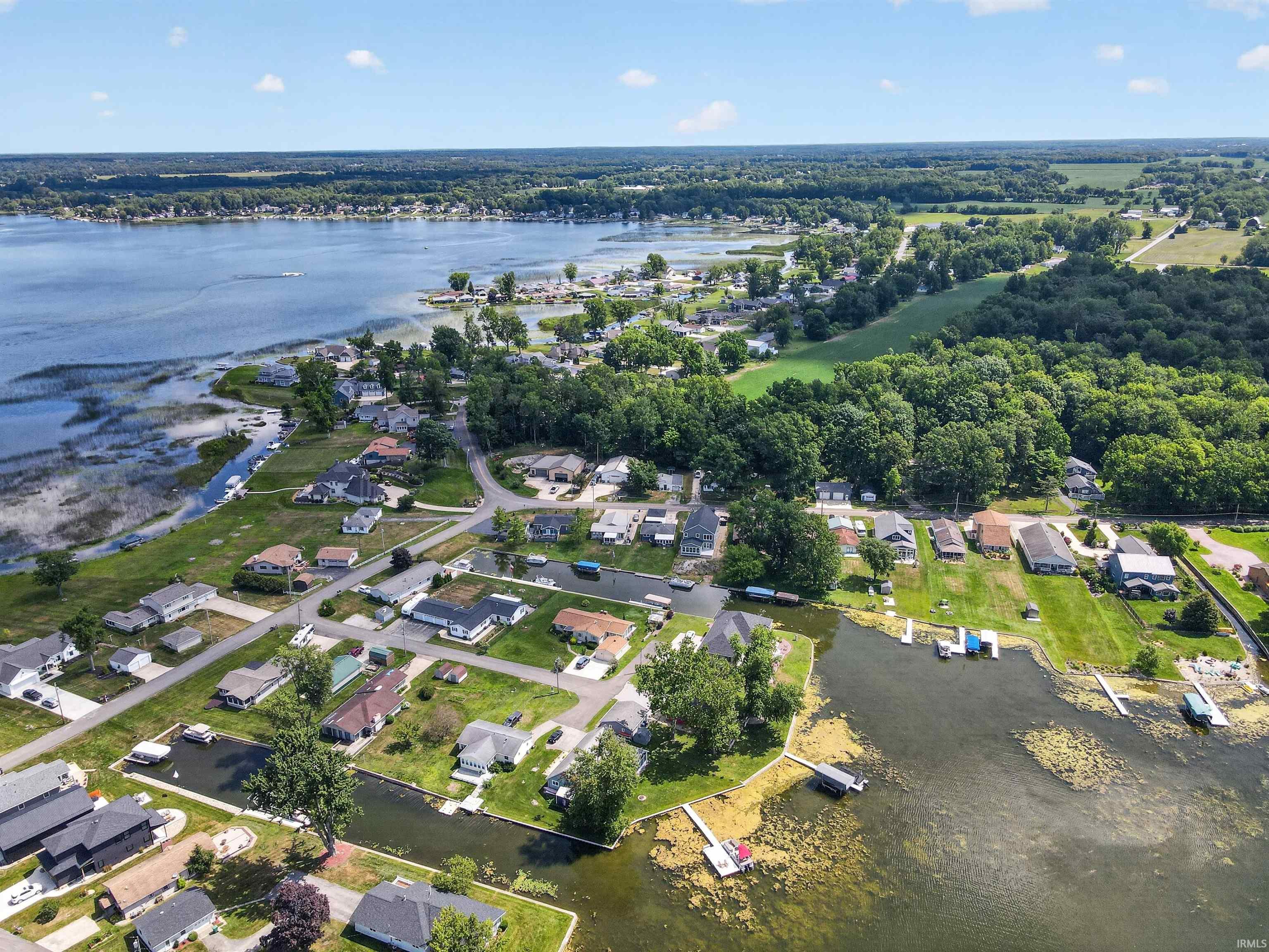 Aerial perspective showcasing a residential area bordered by a large body of water