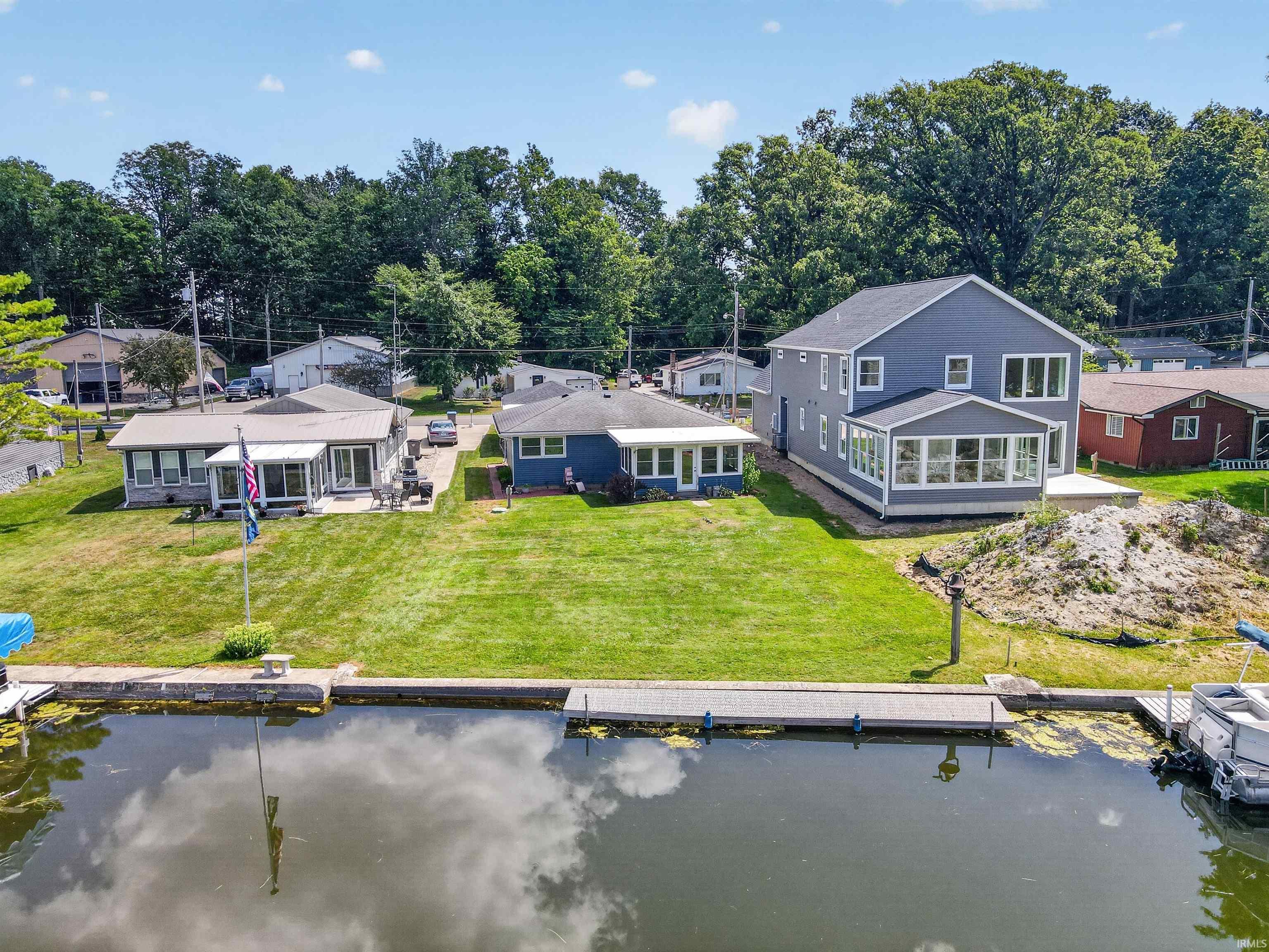 Waterfront property featuring a private dock and a expansive grassy area